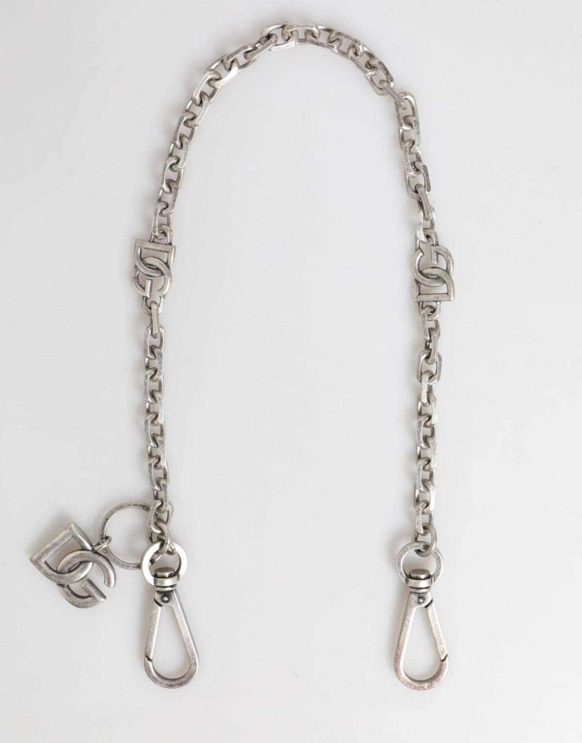 Discover the Dolce & Gabbana Silver Tone Brass DG Logo Detailing Chain Necklace, a masterpiece of Italian craftsmanship that embodies timeless elegance and refined luxury.