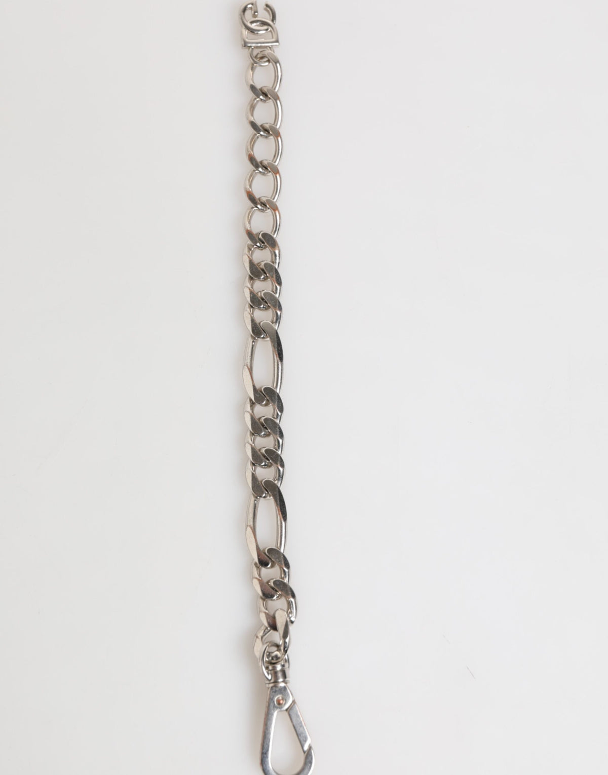 Discover the Dolce & Gabbana Silver Tone Brass Chain DG Logo Bracelet, a masterpiece of Italian craftsmanship that embodies timeless elegance and refined luxury.