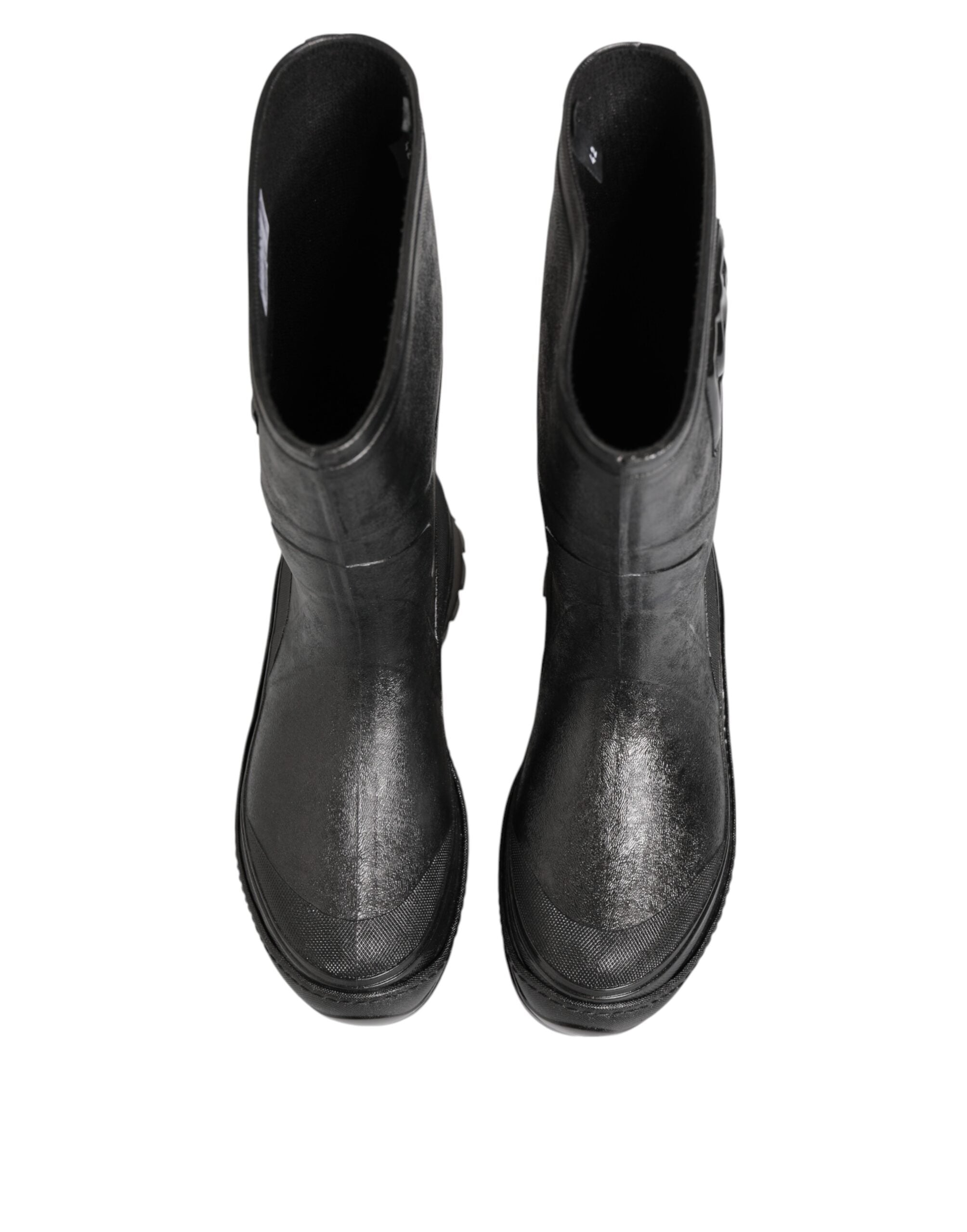Elevate your style with Dolce & Gabbana's Metallic Black Pull On Rain Boots, crafted in Italy from premium PVC and leather, embodying luxury and sophistication for every occasion.
