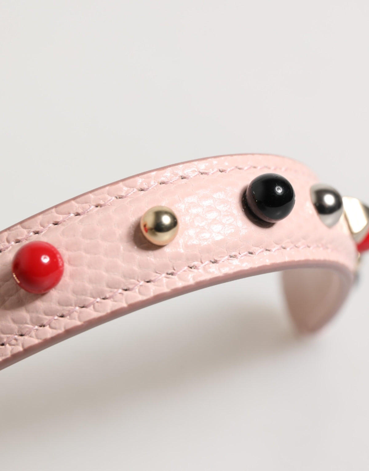 Discover the Dolce & Gabbana Light Pink Embellished Leather Shoulder Strap, a symbol of Italian luxury crafted from 100% calf leather, perfect for elevating your style.