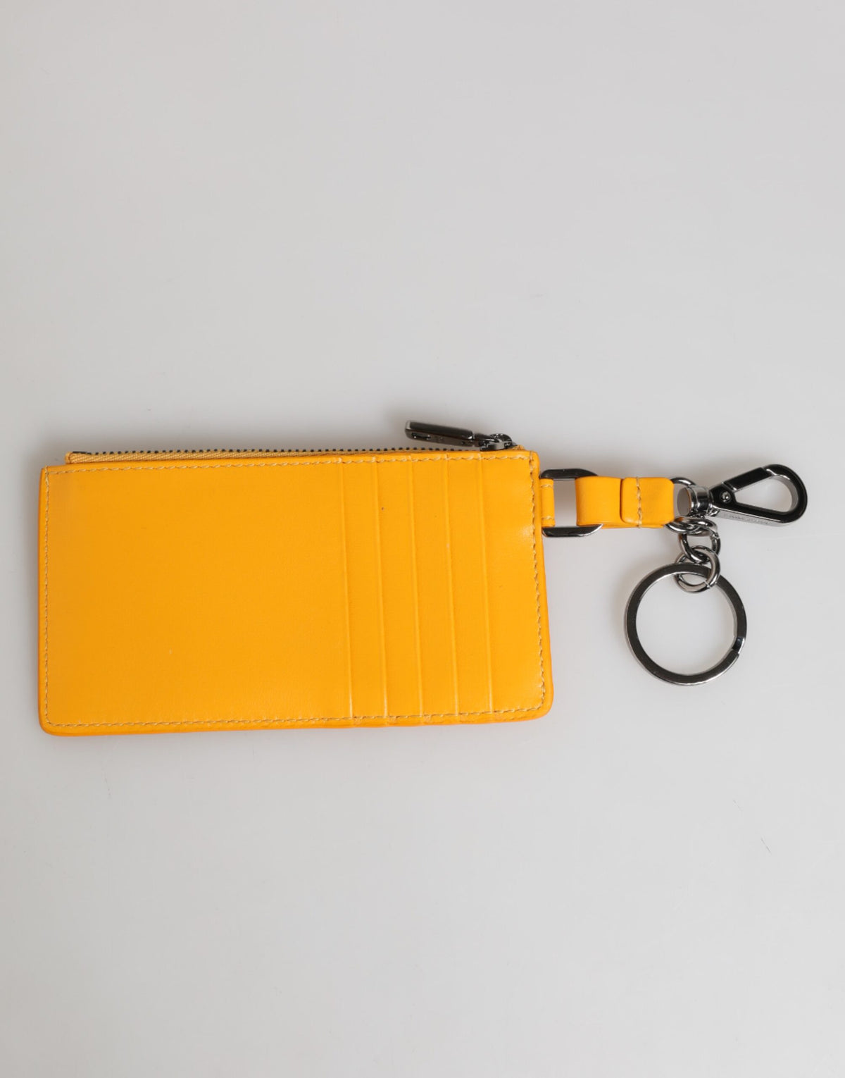 Elevate your style with the Dolce & Gabbana Yellow Orange Leather Credit Card Key Holder, a masterpiece of Italian craftsmanship that seamlessly blends luxury and functionality.