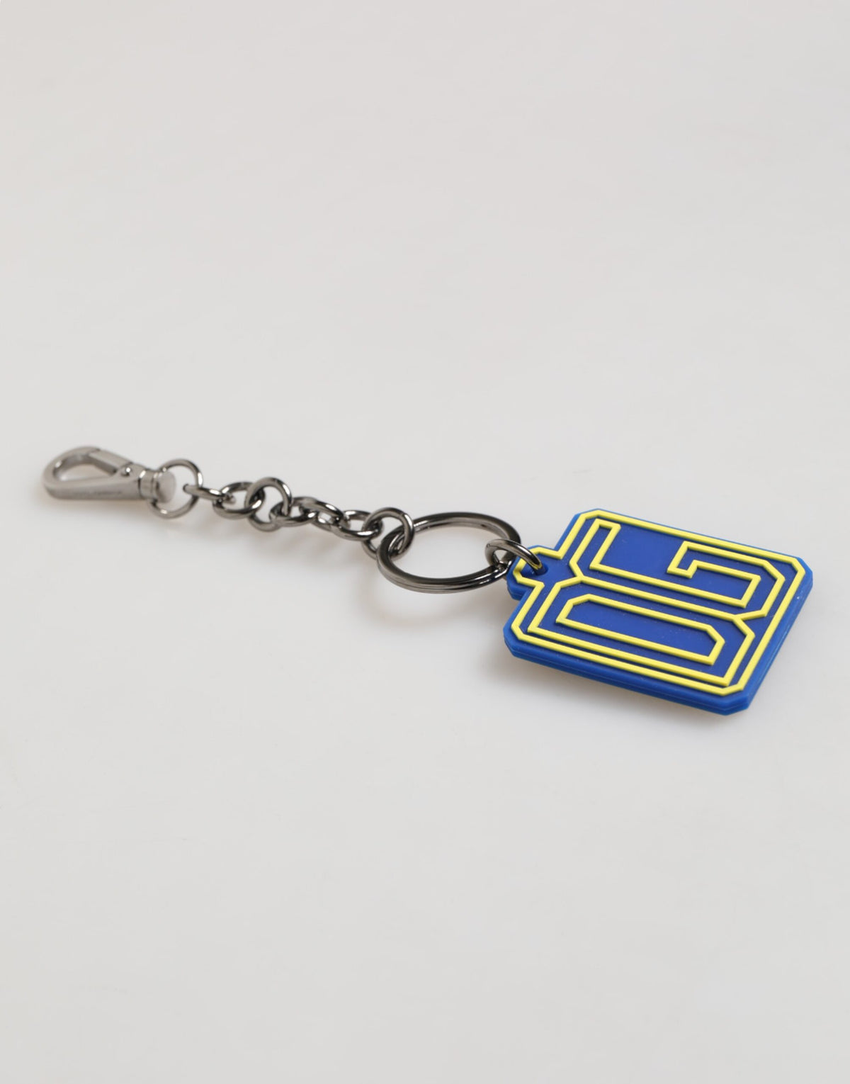 Elevate your essentials with the Dolce & Gabbana Blue Yellow DG Rubber Logo Keychain, a luxurious blend of craftsmanship and artistry that embodies refined sophistication.