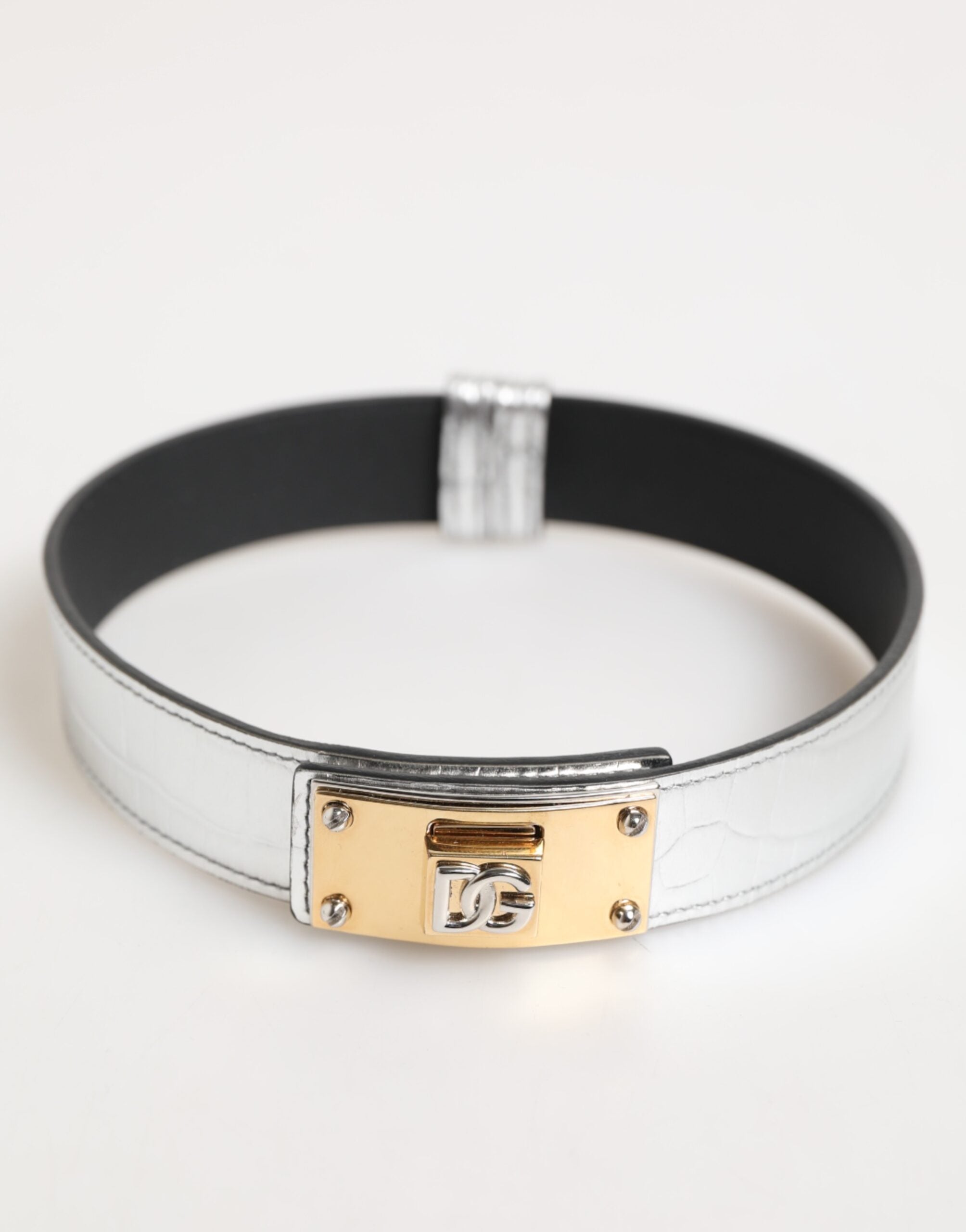 Indulge in the exquisite Dolce & Gabbana Silver Textured Leather Gold Tone Metal Neckband, a statement of modern elegance crafted in Italy, embodying timeless allure and unparalleled craftsmanship.