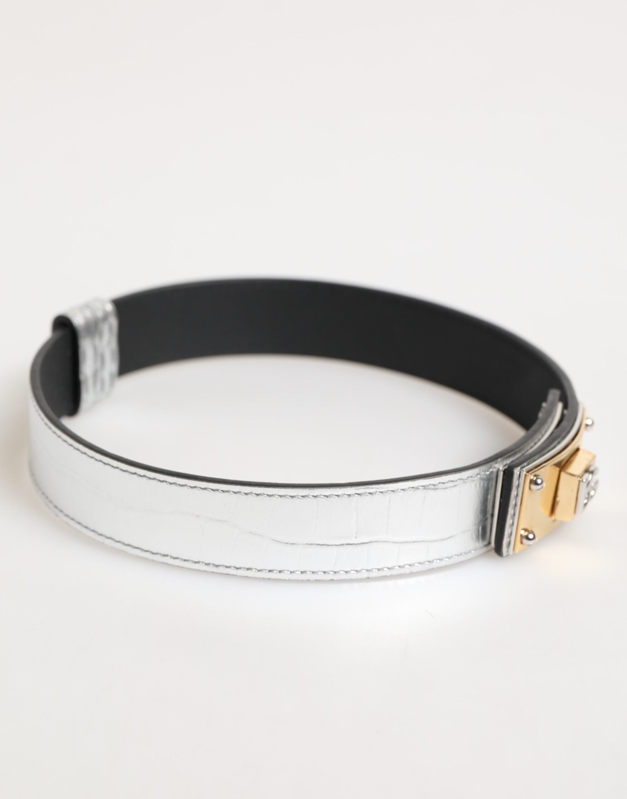 Indulge in the exquisite Dolce & Gabbana Silver Textured Leather Gold Tone Metal Neckband, a masterpiece of Italian craftsmanship that elevates your style with timeless elegance and luxurious allure.