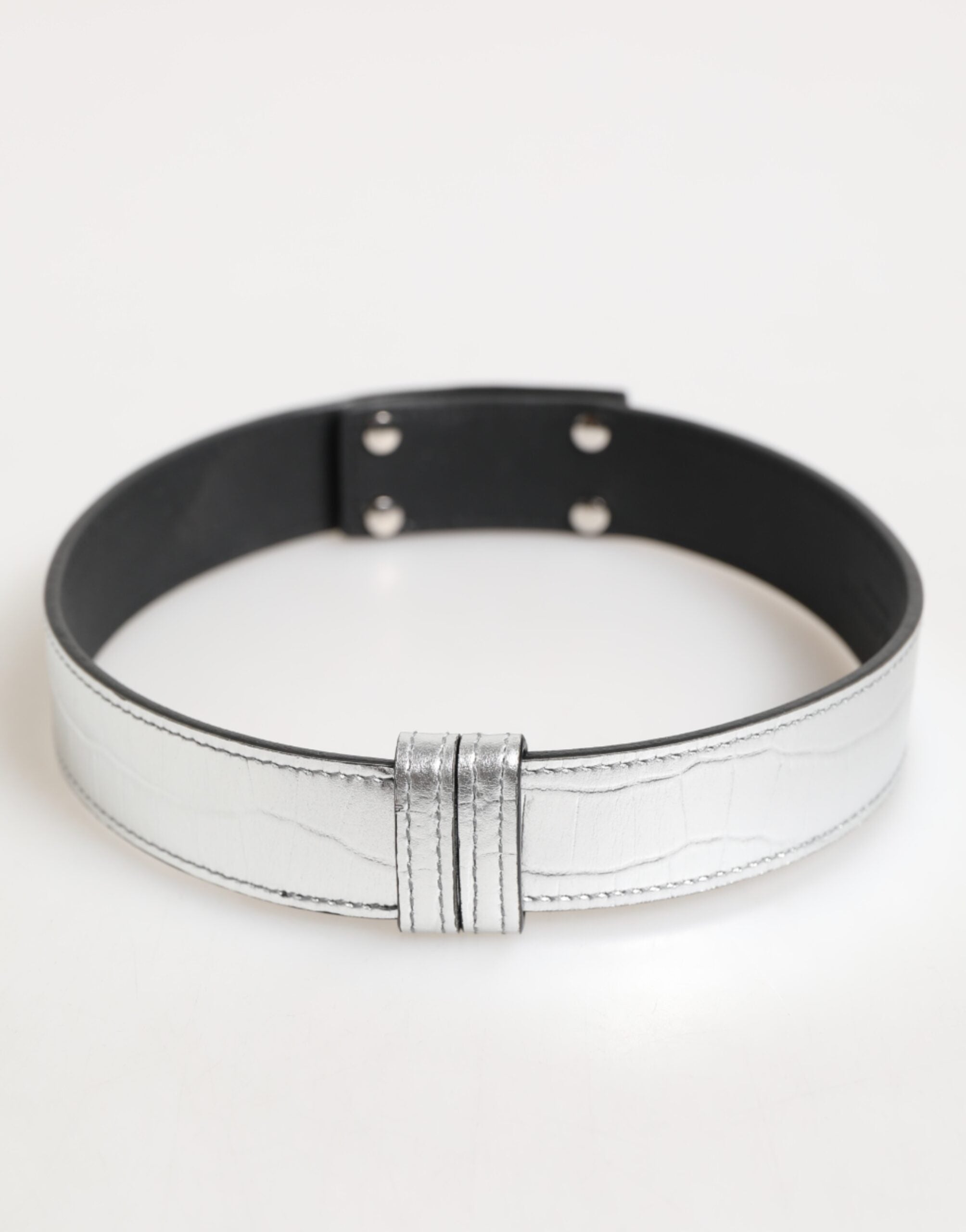 Indulge in the exquisite Dolce & Gabbana Silver Textured Leather Neckband, a masterpiece of Italian craftsmanship that embodies modern elegance and timeless allure.