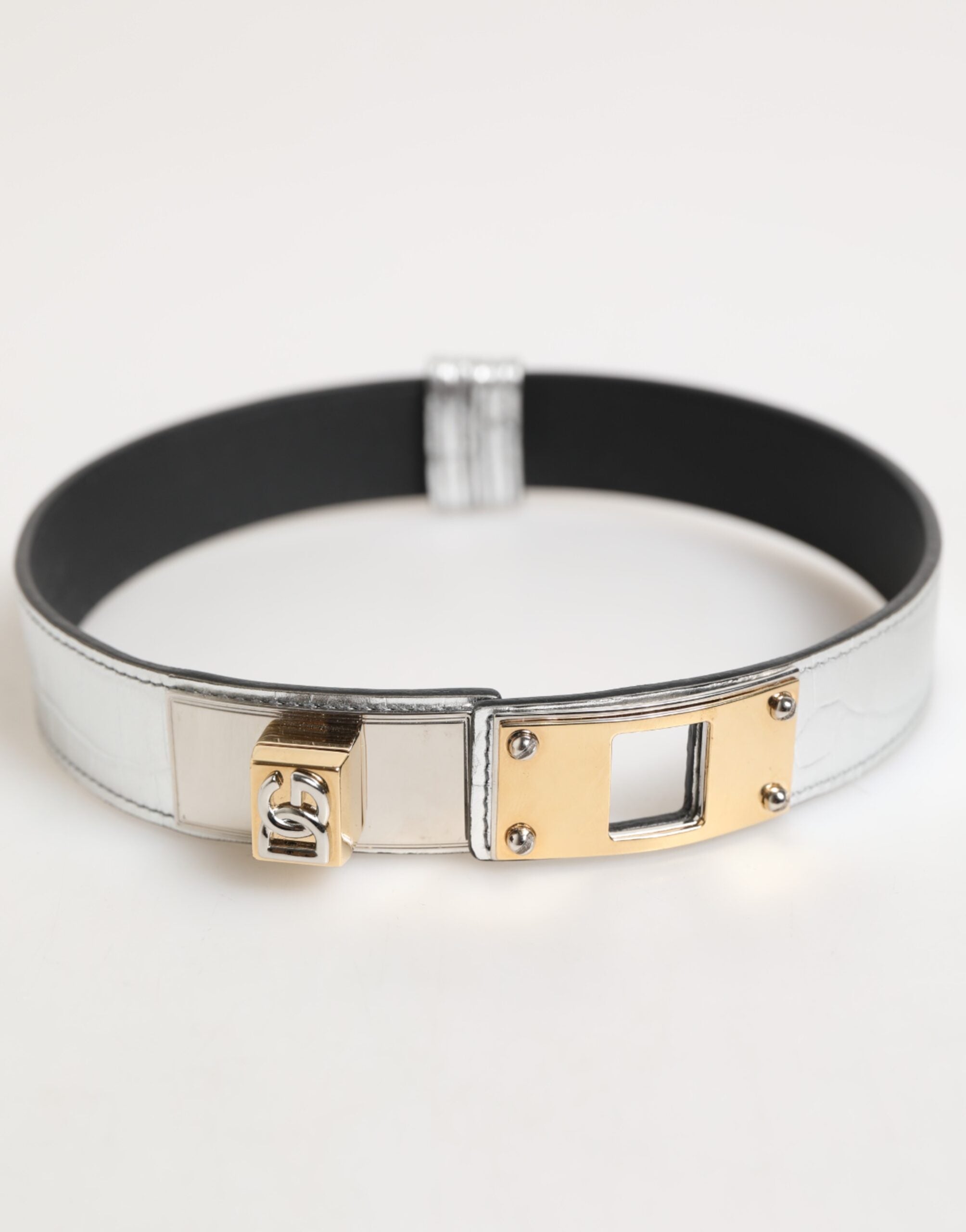 Indulge in the Dolce & Gabbana Silver Textured Leather Gold Tone Metal Neckband, a masterpiece of Italian craftsmanship that elevates your style with luxurious elegance.