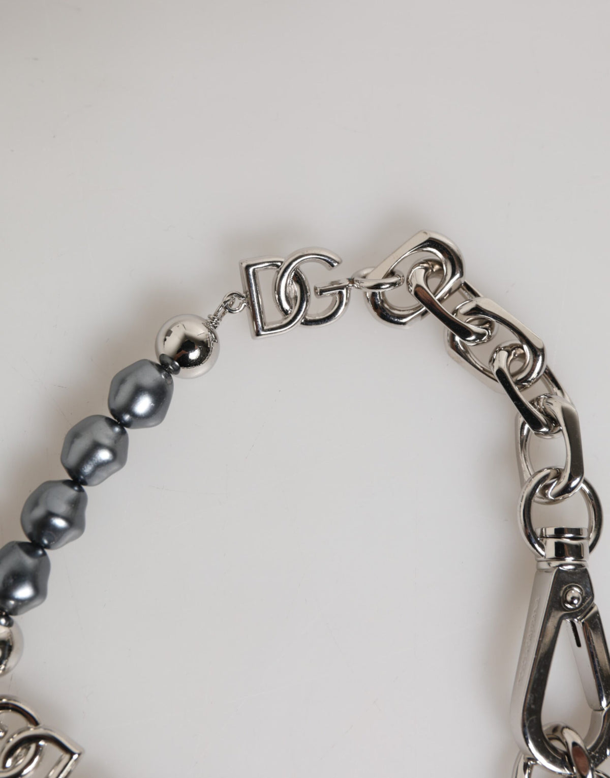 Indulge in the exquisite Dolce & Gabbana Silver Tone Chain Lobster Clasp Logo Gray Pearls Bracelet, a luxurious statement piece that embodies timeless elegance and sophisticated allure.