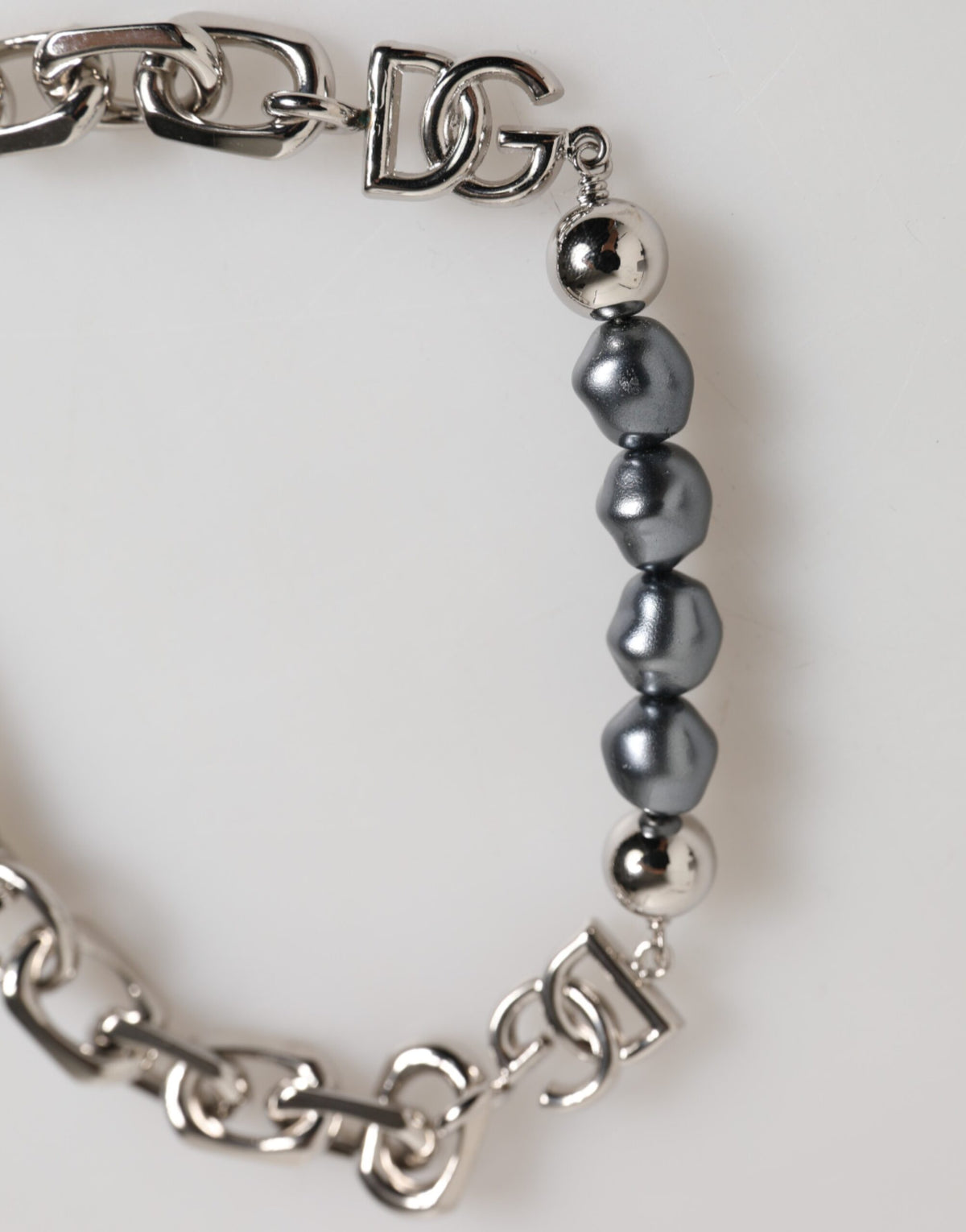 Indulge in the exquisite allure of the Dolce & Gabbana Silver Tone Chain Lobster Clasp Logo Gray Pearls Bracelet, a luxurious statement piece embodying timeless elegance and sophisticated craftsmanship.