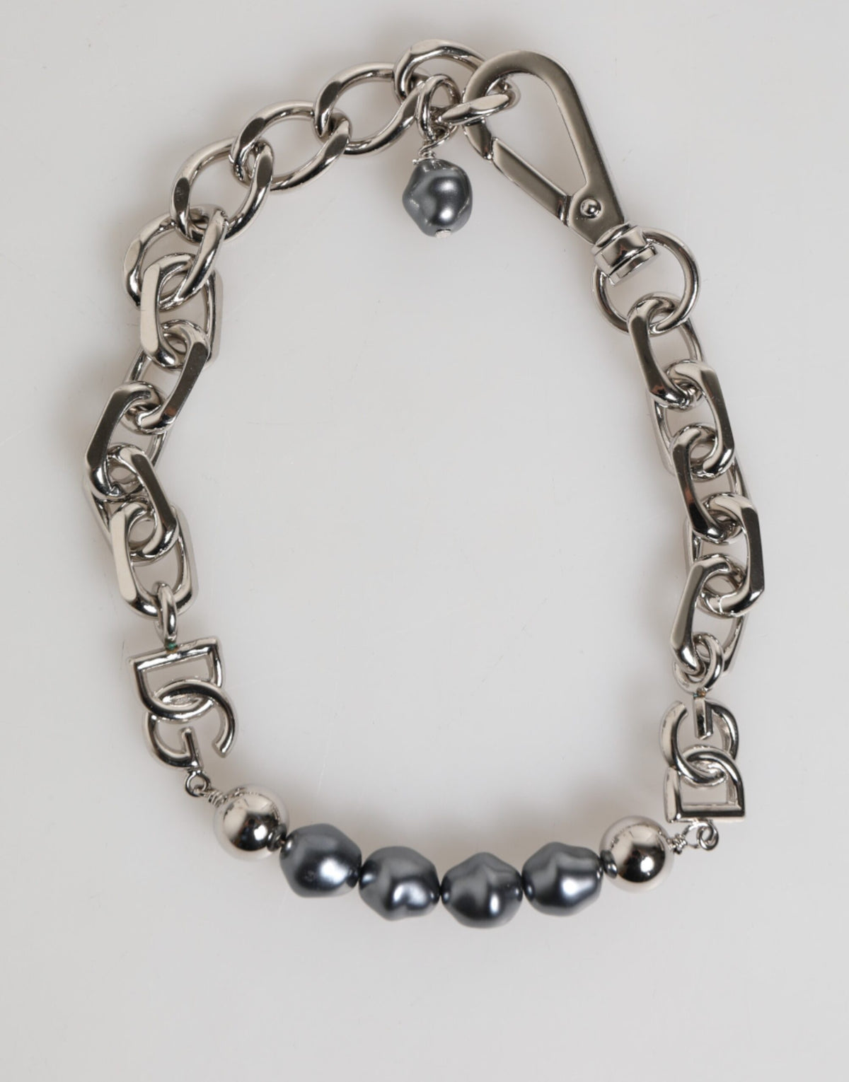 Indulge in the exquisite Dolce & Gabbana Silver Tone Chain Lobster Clasp Logo Gray Pearls Bracelet, a luxurious statement piece that embodies timeless elegance and sophistication.