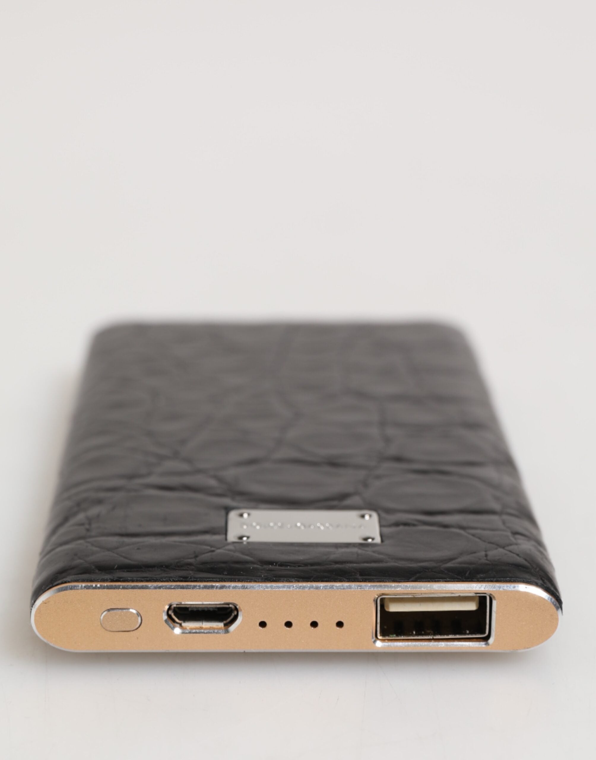 Discover the Dolce & Gabbana Black Leather Exotic Skin Power Bank, where exquisite craftsmanship meets luxury, ensuring elegance and functionality for the discerning individual.