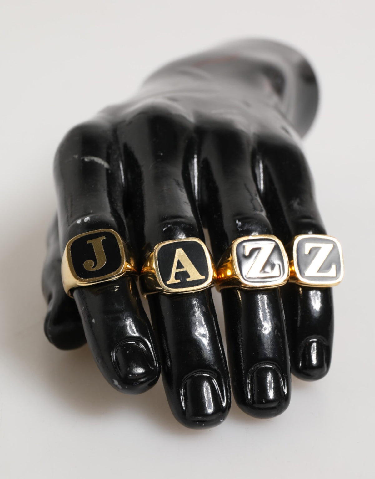 Indulge in the opulence of Dolce & Gabbana's Gold Tone Brass JAZZ Letter Set, where exquisite Italian craftsmanship meets luxurious elegance, perfect for any occasion.