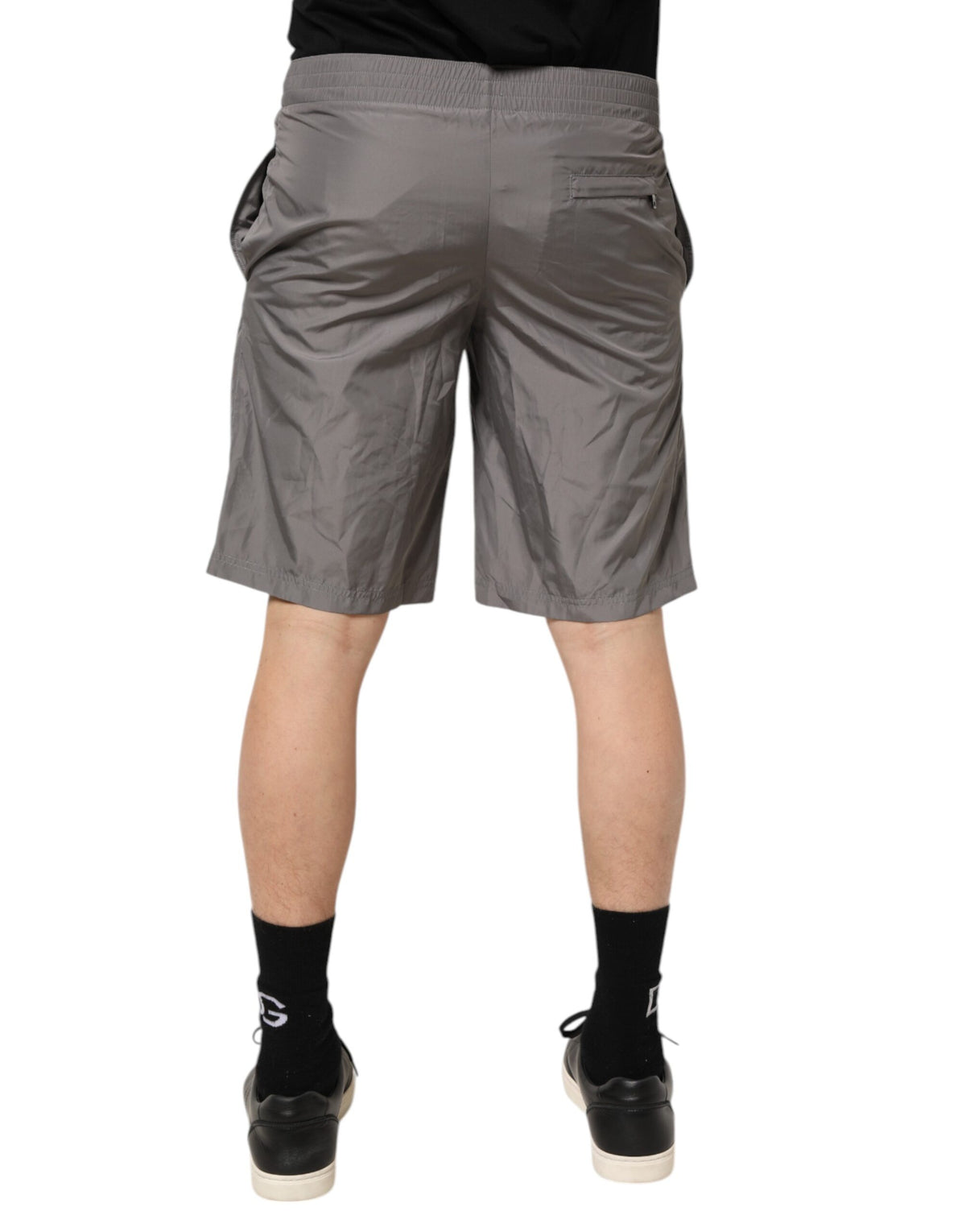 Elevate your beachside allure with Dolce & Gabbana's Light Gray Nylon Elastic Waist Shorts, a luxurious blend of Italian craftsmanship and timeless elegance.