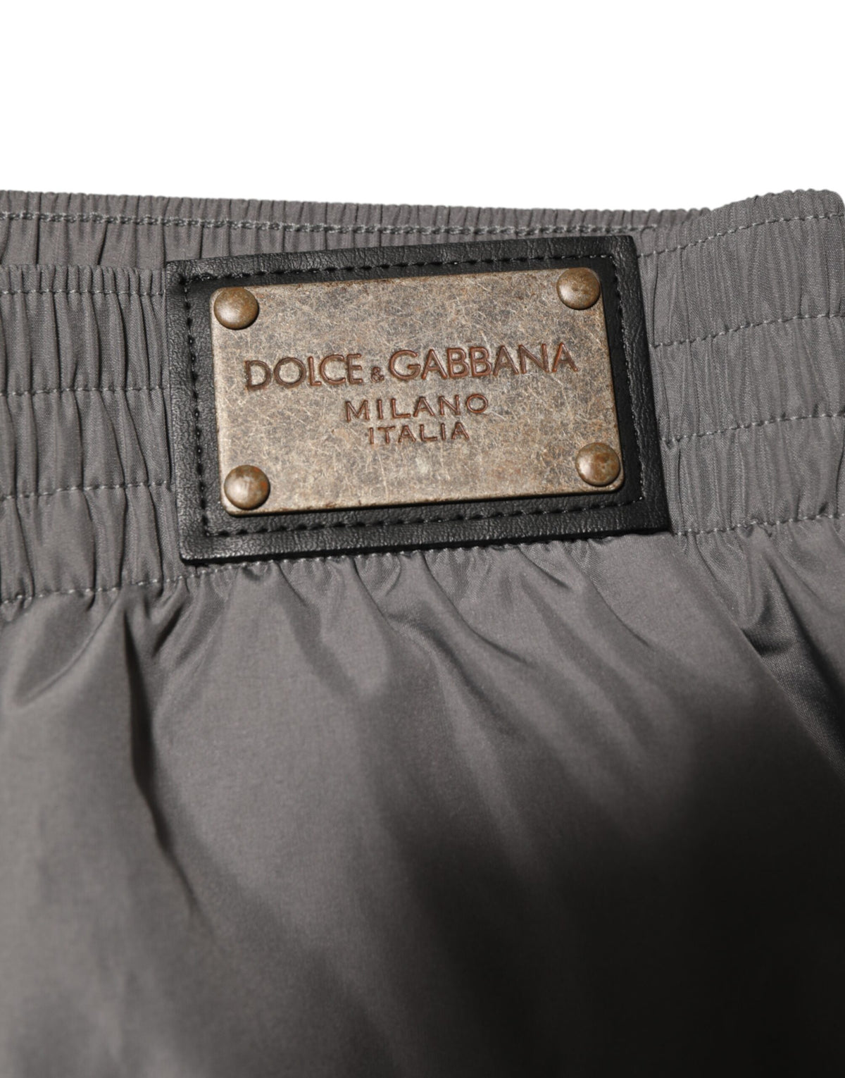 Elevate your beachwear collection with Dolce & Gabbana's Light Gray Nylon Elastic Waist Shorts, a blend of Italian craftsmanship and timeless elegance for discerning individuals.