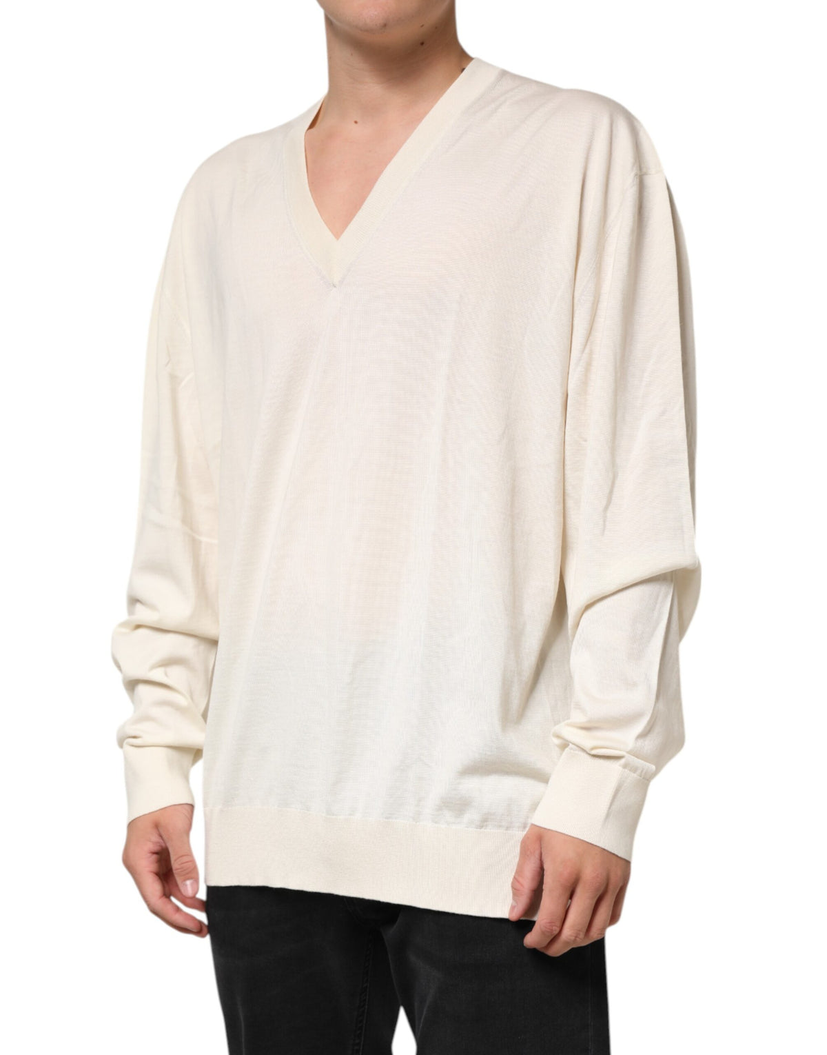 Elevate your wardrobe with the Dolce & Gabbana Ivory Virgin Wool V-Neck Knit Sweater, a masterpiece of Italian craftsmanship blending luxury and timeless elegance.