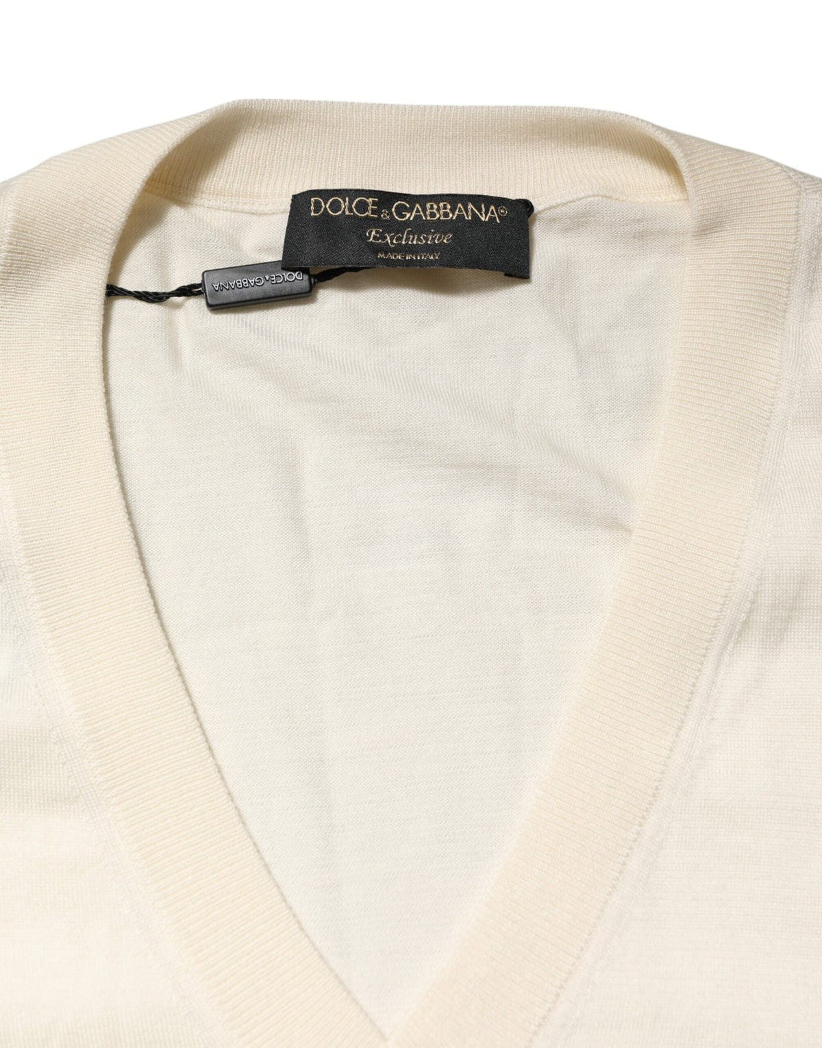 Indulge in the exquisite Dolce & Gabbana Ivory Virgin Wool V-Neck Knit Sweater, a timeless blend of 70% virgin wool and 30% silk, embodying luxury and sophistication.
