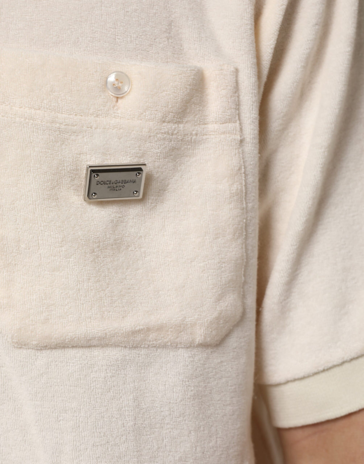 Discover the Dolce & Gabbana Ivory Cotton Terry Logo Pocket Polo T-shirt, a masterpiece of Italian craftsmanship that embodies timeless elegance and sophisticated allure.