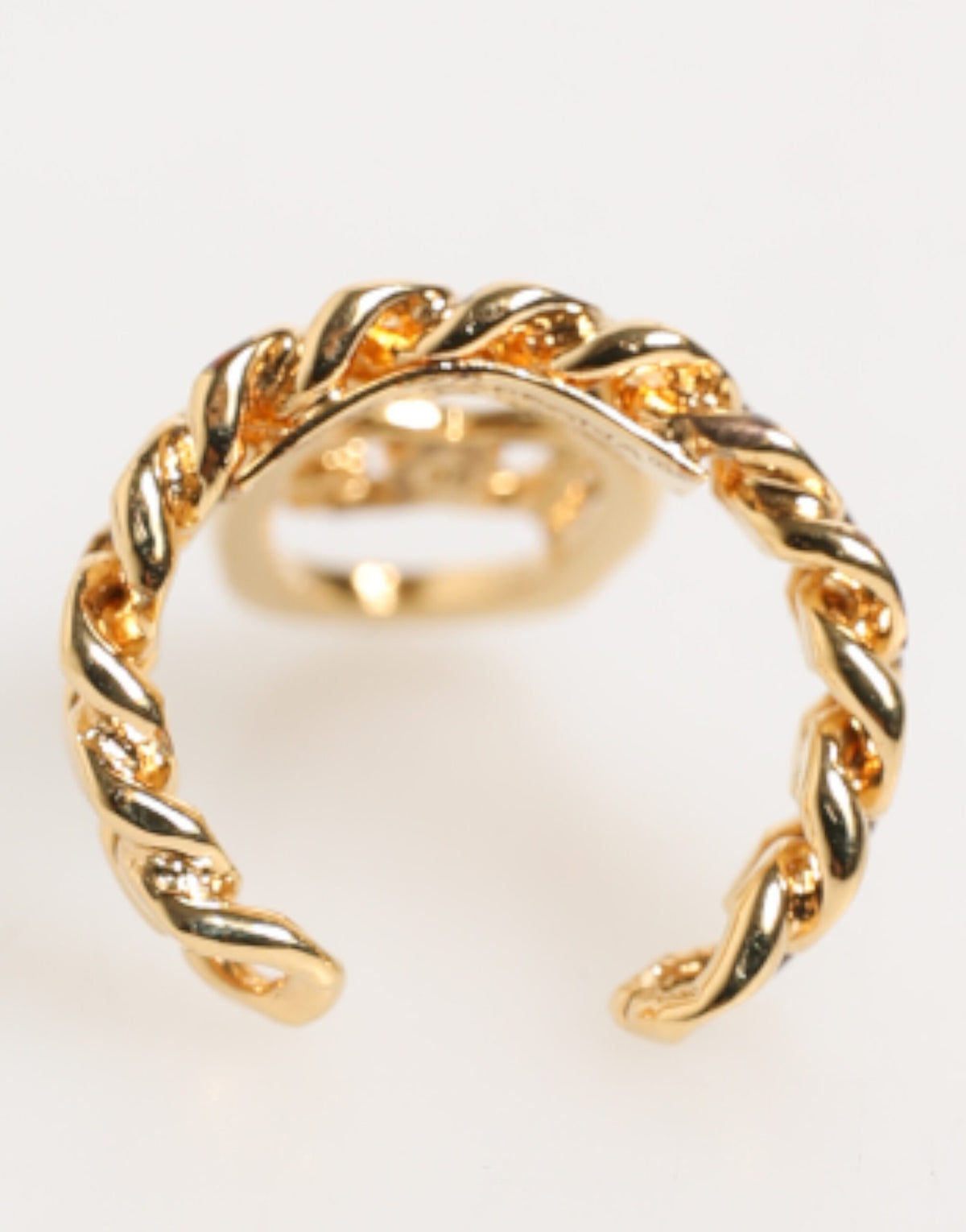 Discover the Dolce & Gabbana Gold Tone Brass Oval DG Logo Chain Adjustable Ring, a luxurious statement piece that embodies elegance and sophistication for the discerning individual.