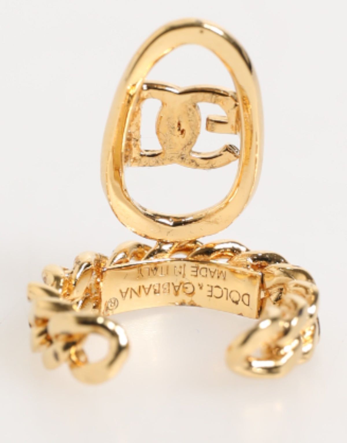 Elevate your elegance with the Dolce & Gabbana Gold Tone Brass Oval DG Logo Chain Adjustable Ring, a luxurious statement piece crafted in Italy that embodies refined sophistication.