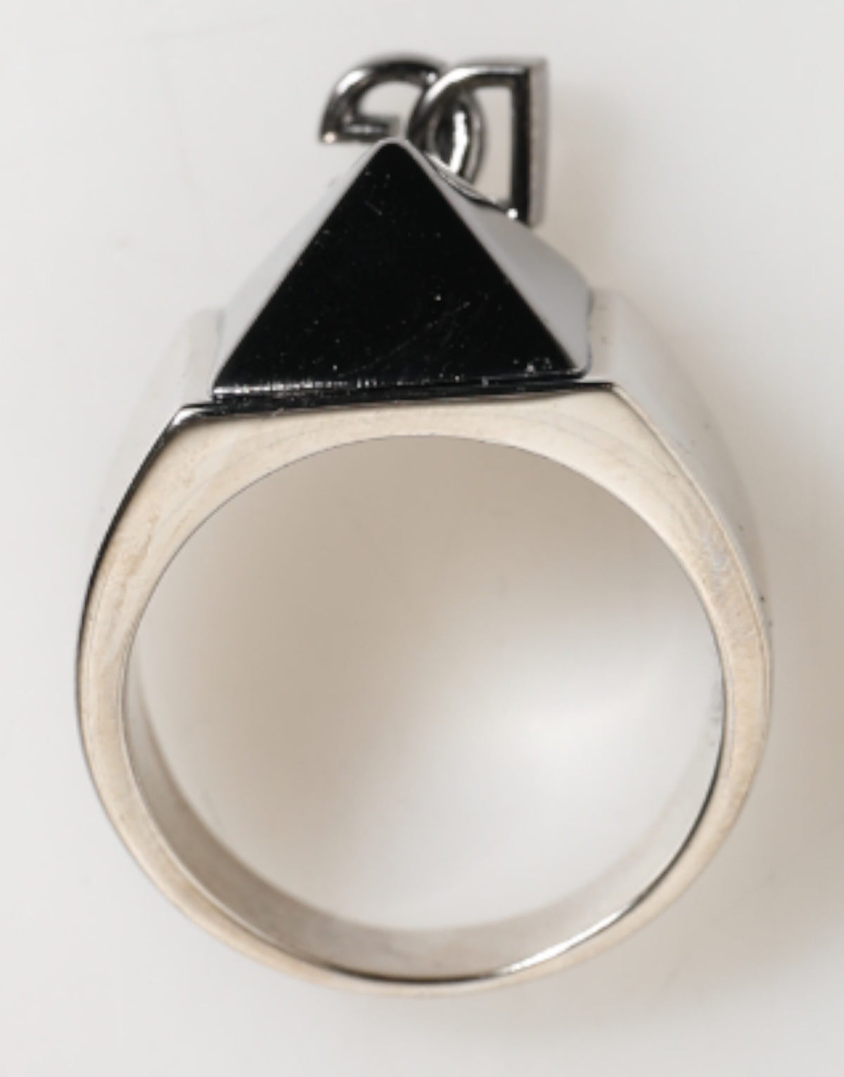 Discover the Dolce & Gabbana Silver Tone Pyramid DG Logo Ring, a testament to Italian craftsmanship and modern elegance, perfect for the discerning individual.