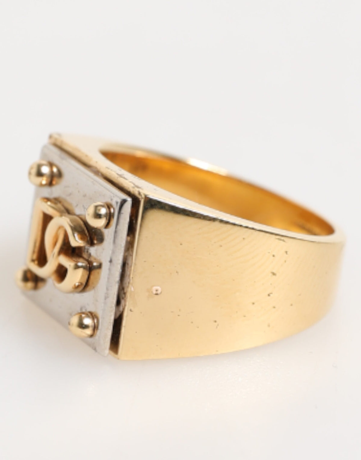 Discover the Dolce & Gabbana Gold Tone Brass Signet Ring, a luxurious expression of artistry and sophistication, perfect for those who embody timeless elegance.
