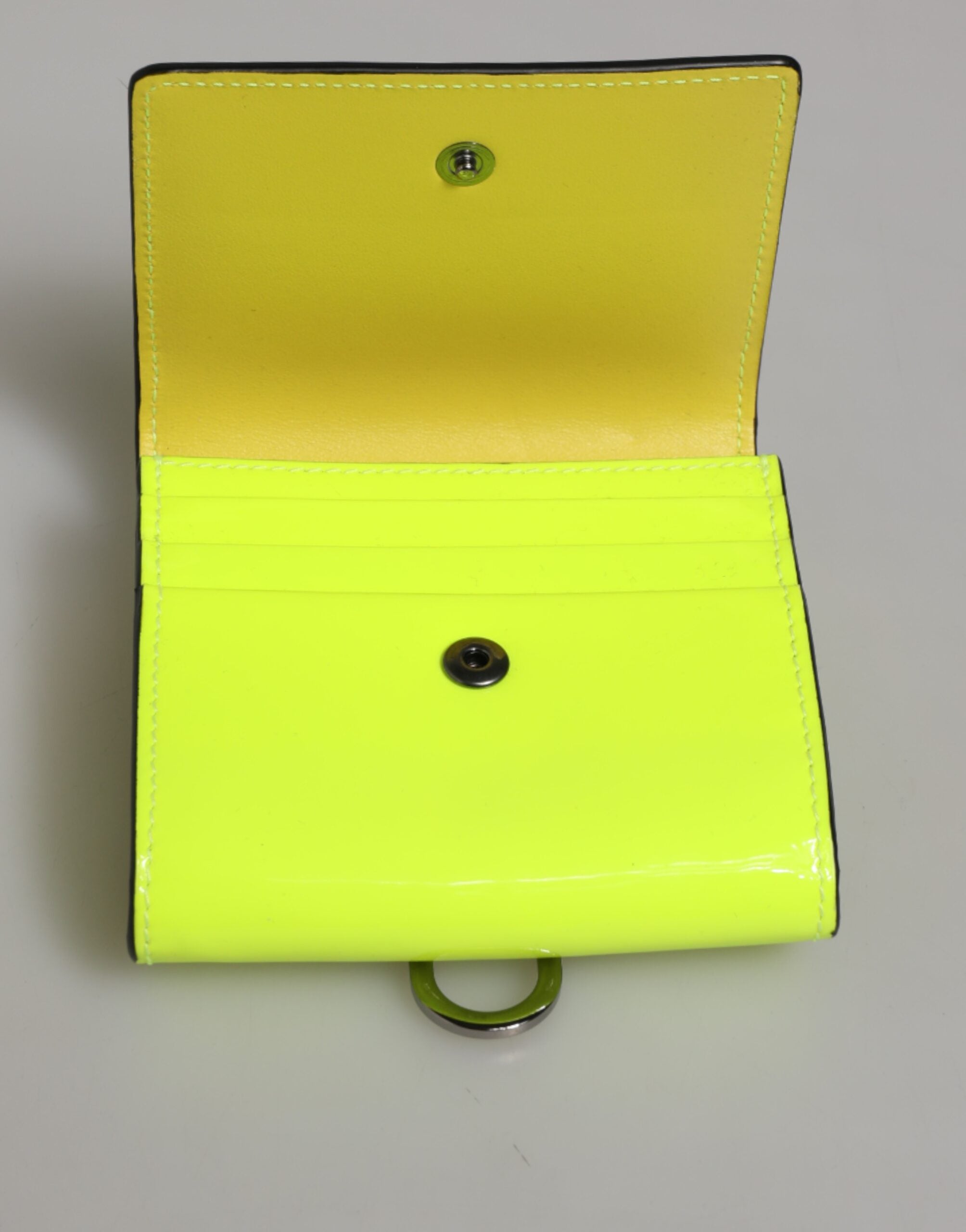 Elevate your elegance with the Dolce & Gabbana Yellow Green Bifold DG Logo Neck Strap Cardholder Wallet, a luxurious calf leather masterpiece that embodies Italian artistry and sophistication.