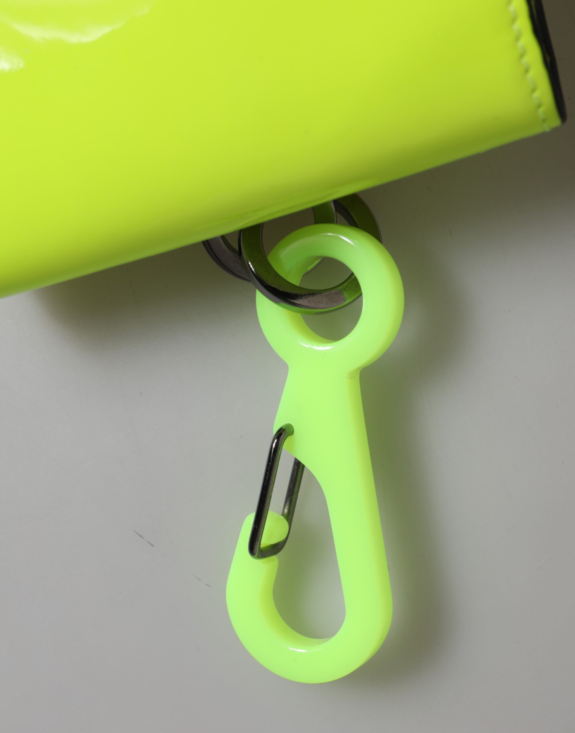 Experience the allure of the Dolce & Gabbana Yellow Green Bifold DG Logo Neck Strap Cardholder, crafted from premium calf leather, embodying luxury and sophistication for the discerning individual.