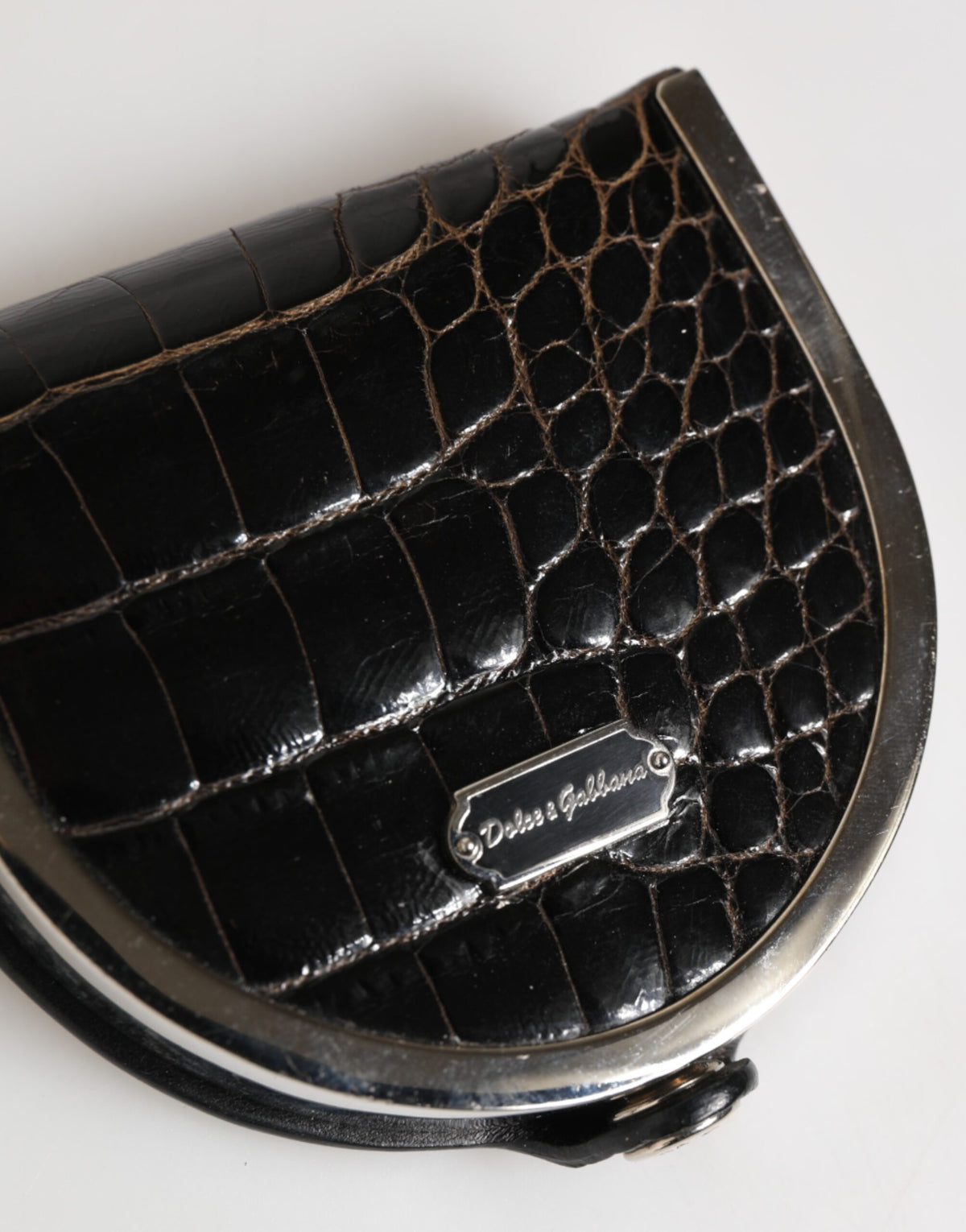 Discover the Dolce & Gabbana Black Polished Crocodile Leather Coin Purse, a timeless symbol of luxury and elegance, crafted from genuine American alligator leather for the discerning individual.