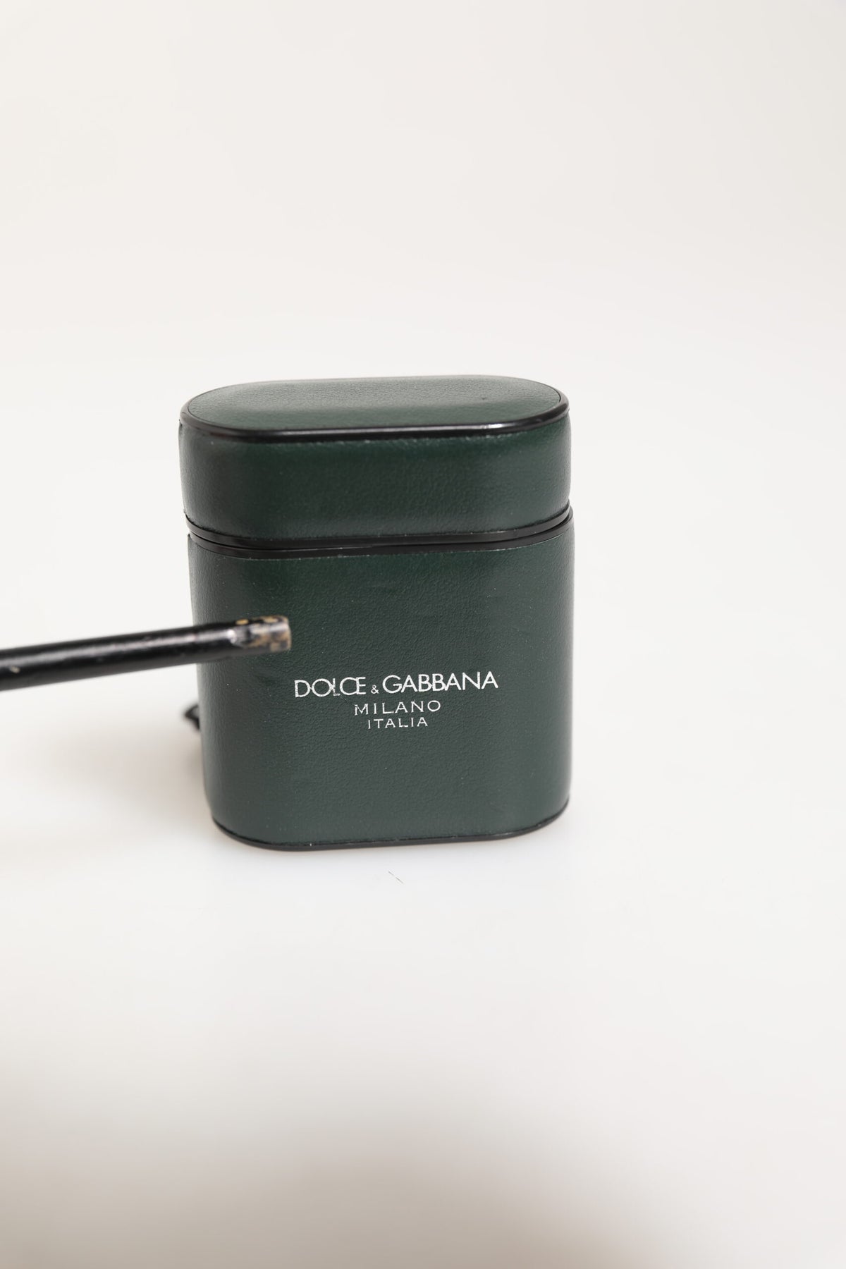 Indulge in the exquisite Dolce & Gabbana Army Green Calfskin Leather Airpods Case, a luxurious blend of Italian craftsmanship and timeless elegance, perfect for discerning tastes.