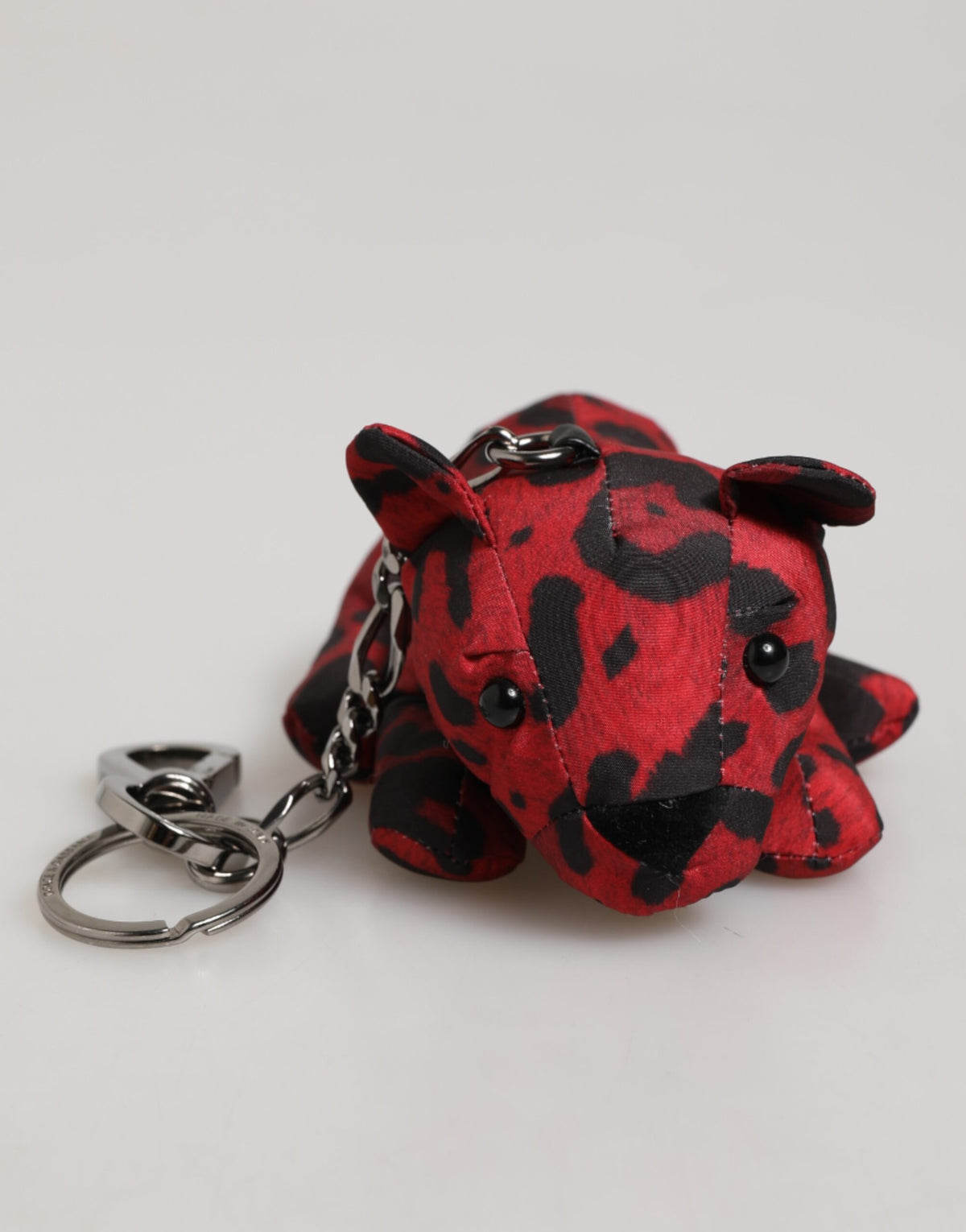 Elevate your accessory collection with the Dolce & Gabbana Red Black Polyester Animal Silhouette Keychain, a luxurious blend of exquisite craftsmanship and iconic design.