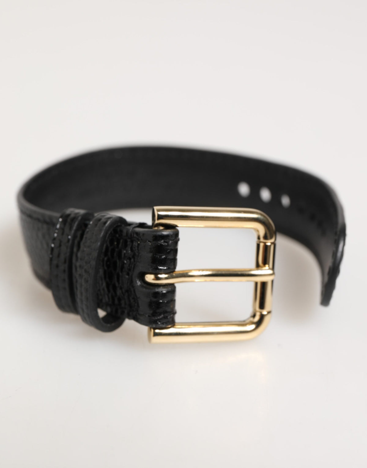 Elevate your style with the Dolce & Gabbana Black Embossed Leather Gold Buckle Belt Strap Bracelet, a testament to Italian craftsmanship and timeless elegance.