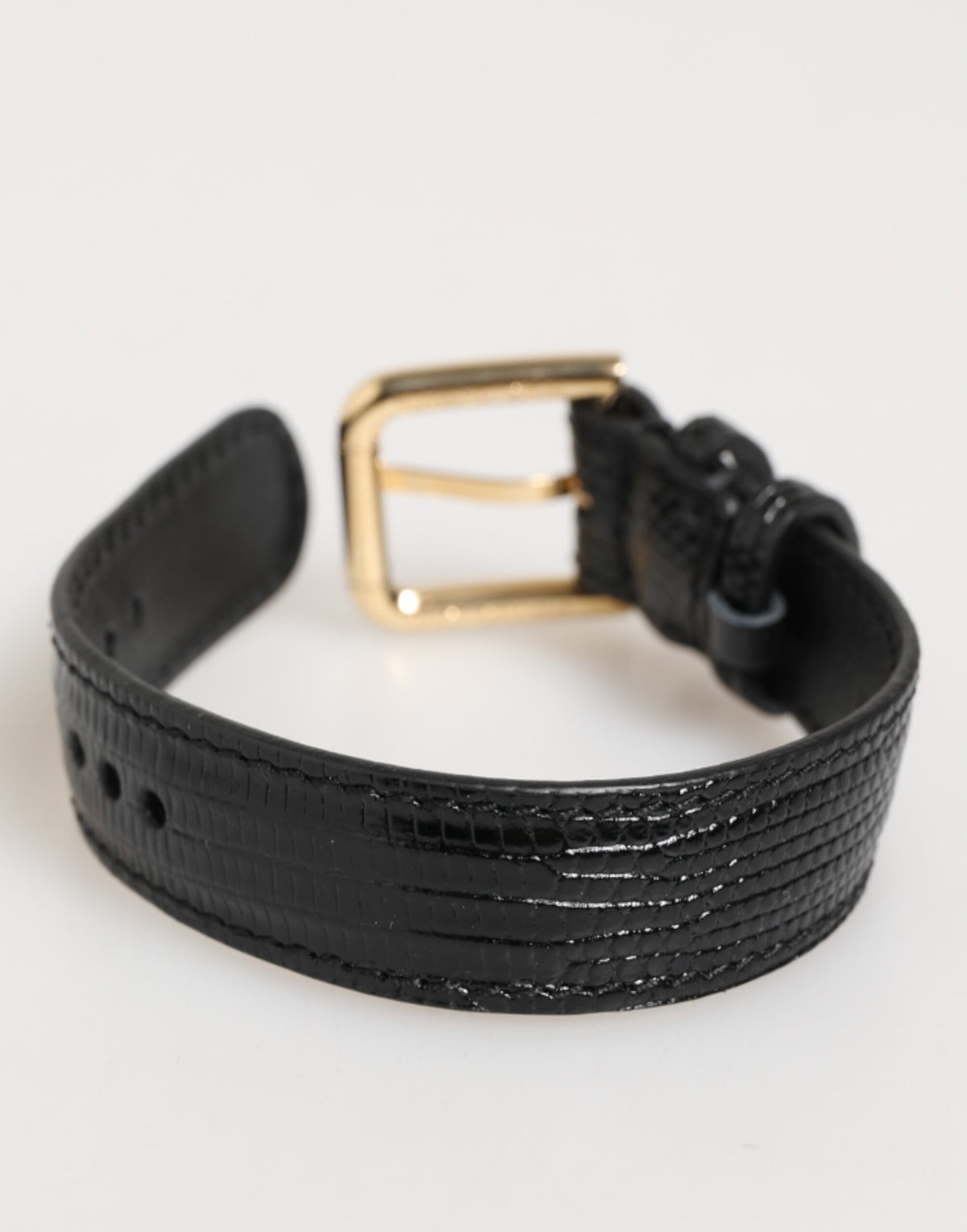 Elevate your style with the Dolce & Gabbana Black Embossed Leather Gold Buckle Belt Strap Bracelet, a testament to Italian craftsmanship and timeless elegance.