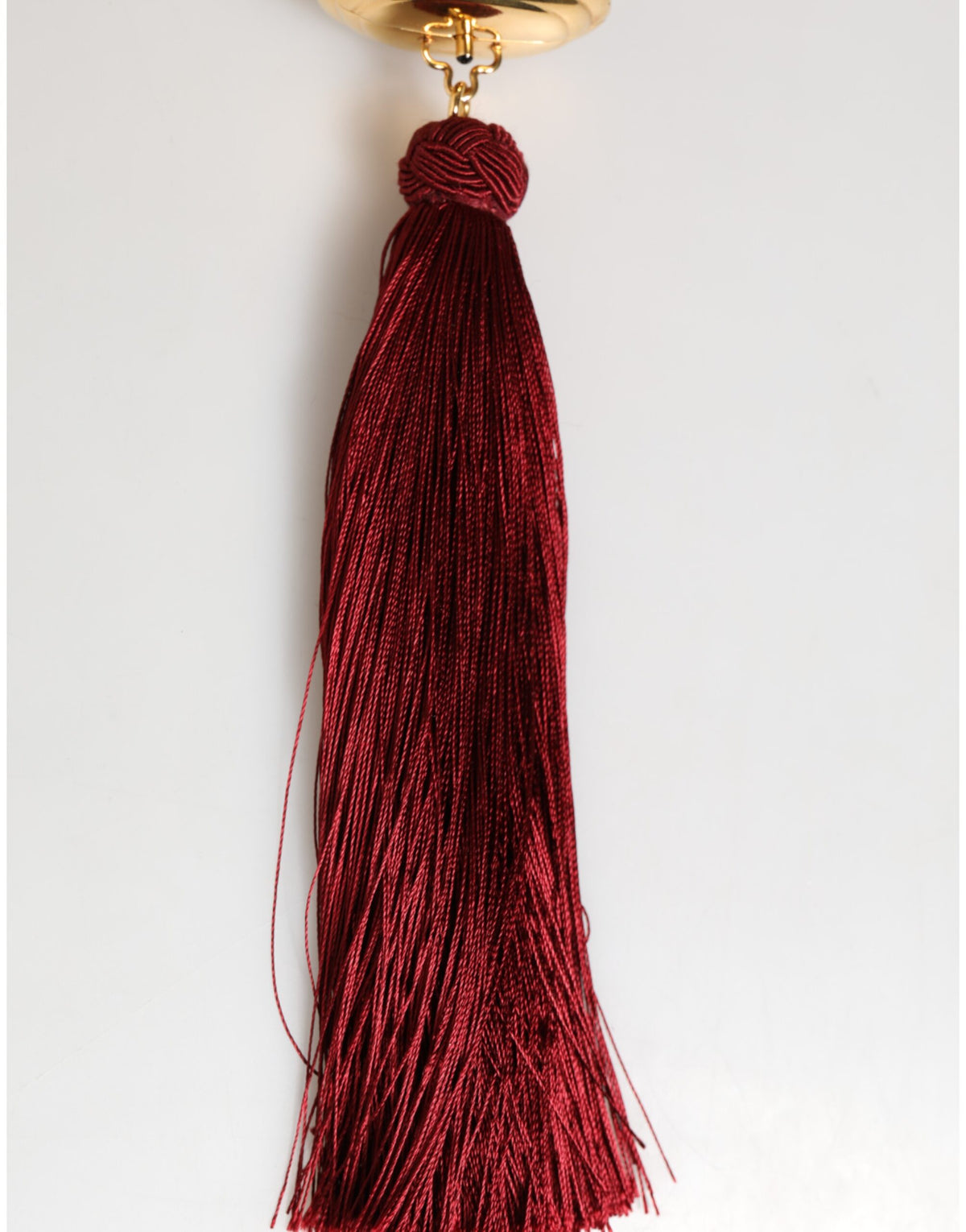 Elevate your style with the Dolce & Gabbana White Pearl Resin Gold Metal Red Tassel Pendant Bag, a timeless masterpiece that embodies exquisite craftsmanship and luxurious allure.