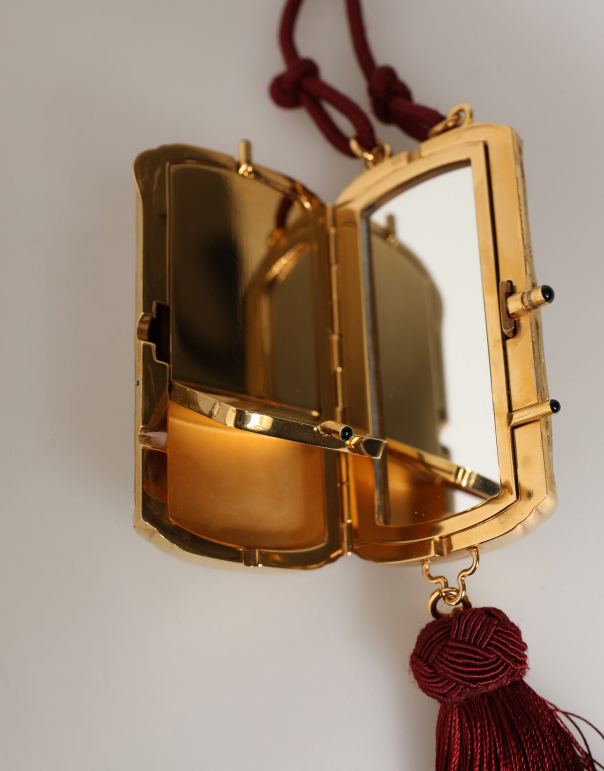 Elevate your style with the Dolce & Gabbana White Pearl Resin Gold Metal Red Tassel Pendant Bag, a symbol of exquisite craftsmanship and timeless luxury.