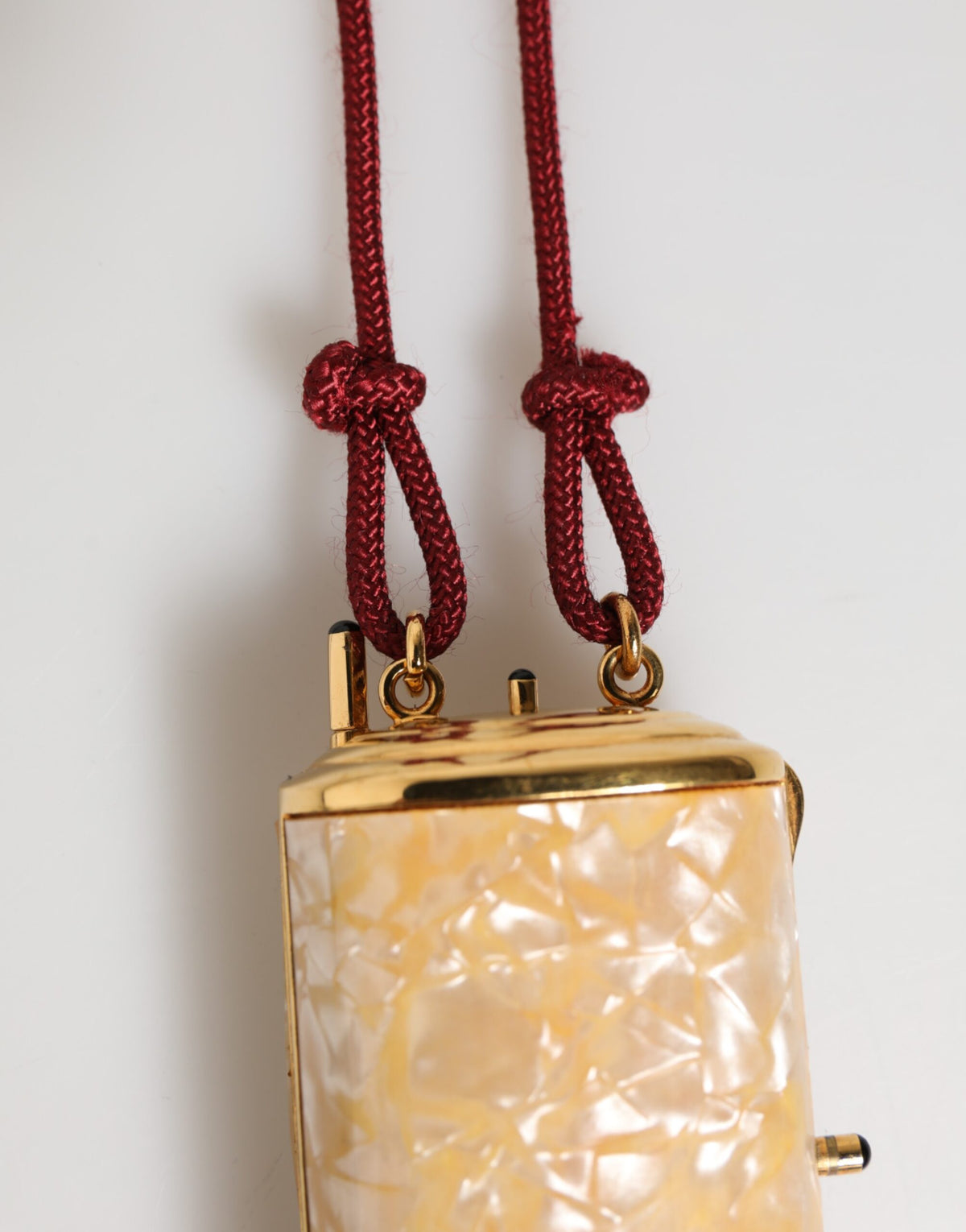 Elevate your style with the Dolce & Gabbana White Resin Gold Metal Crossbody Mini Purse, a luxurious statement piece embodying exquisite craftsmanship and timeless elegance.