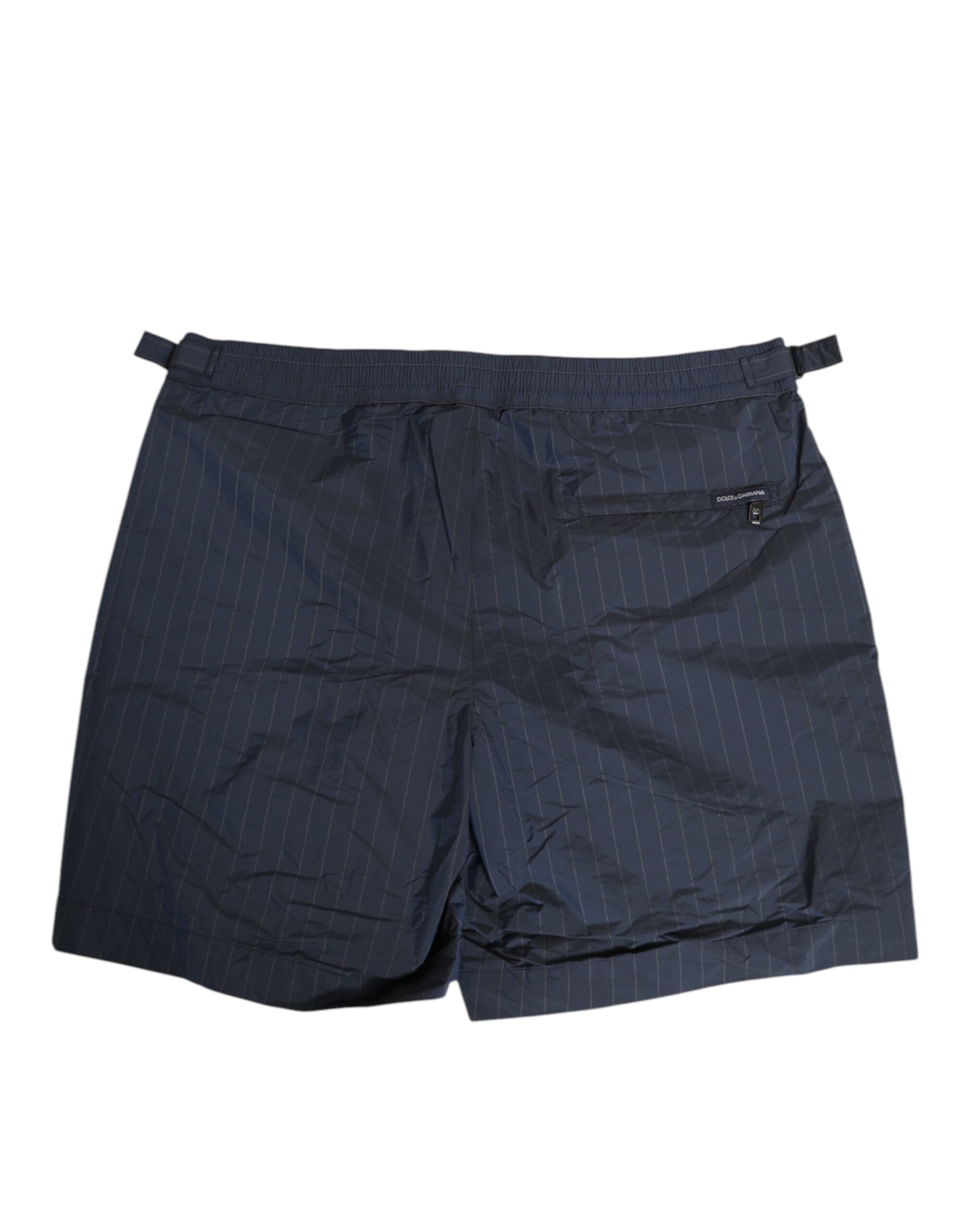 Experience the epitome of elegance with Dolce & Gabbana's navy blue pinstripe swim shorts, crafted from premium materials for effortless sophistication and comfort.