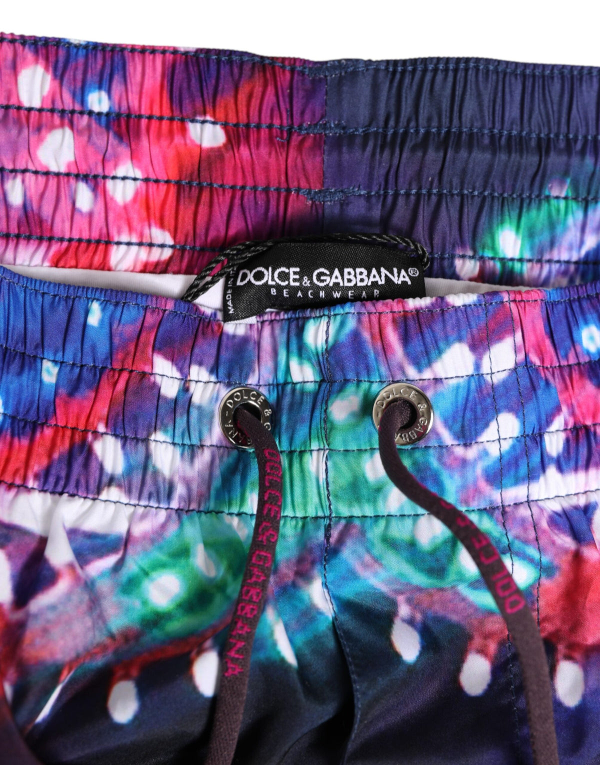 Elevate your summer style with Dolce & Gabbana's Multicolor Neon Print Polyester Shorts, a luxurious blend of vibrant design and superior comfort, perfect for the discerning fashion lover.