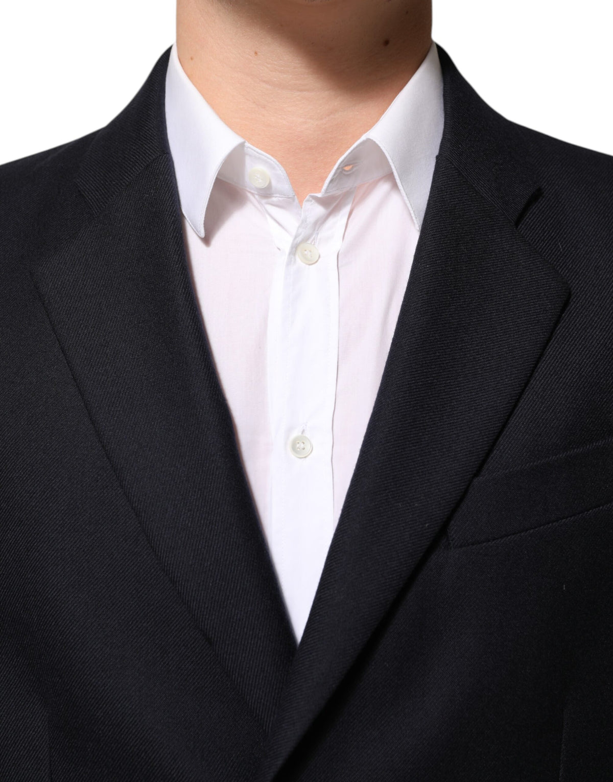 Elevate your style with the Dolce & Gabbana Dark Blue Wool Blazer, crafted from 100% virgin wool, embodying timeless elegance and Italian craftsmanship for the discerning individual.