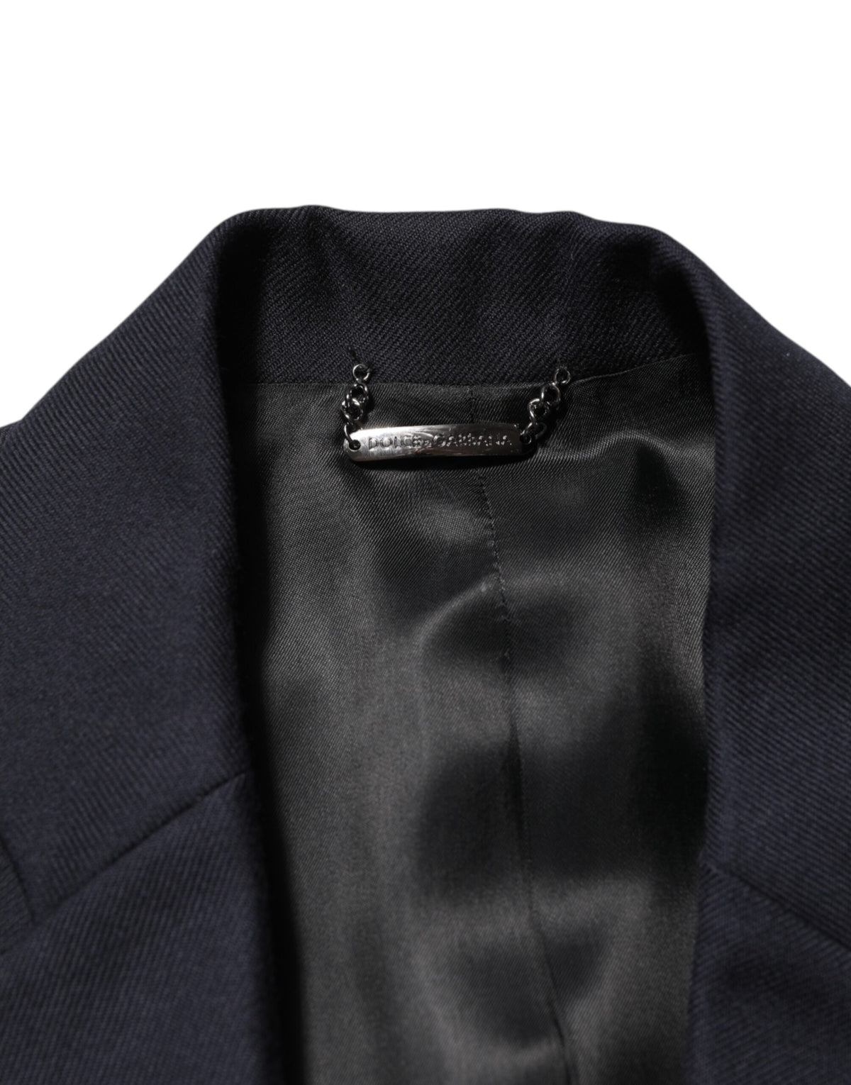 Elevate your style with the Dolce & Gabbana Dark Blue Wool Blazer, a masterpiece of Italian craftsmanship in luxurious virgin wool, embodying timeless elegance and sophistication.