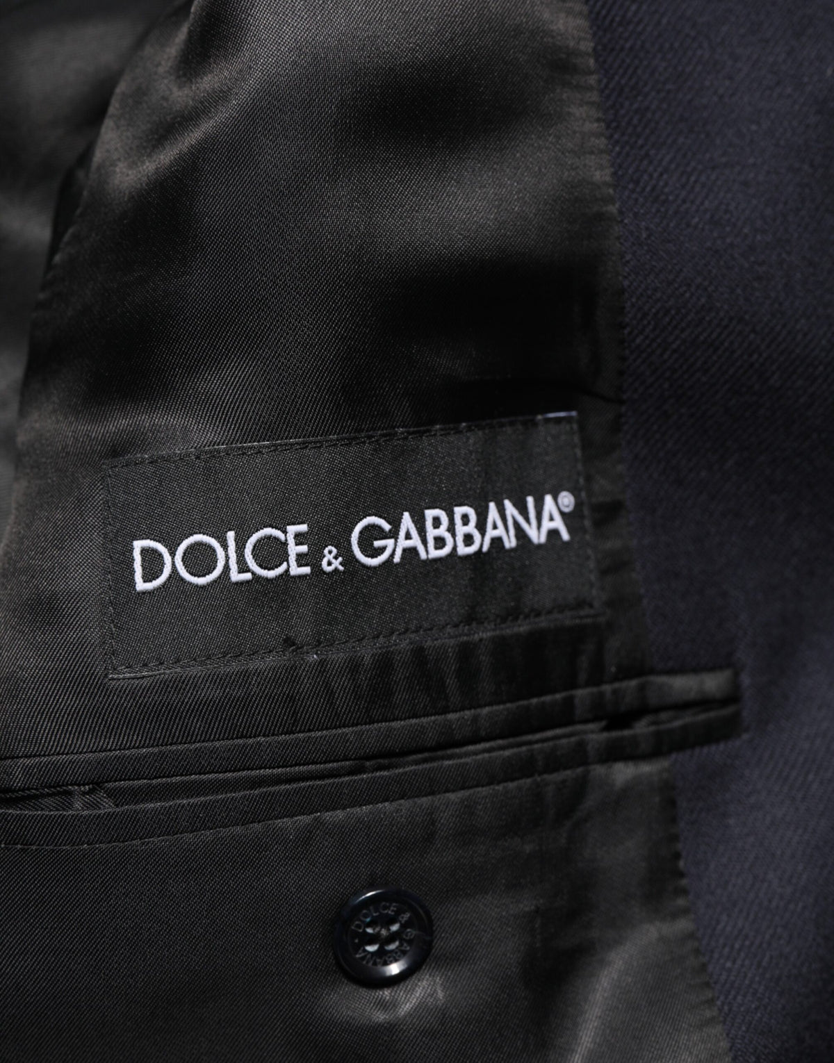 Indulge in the exquisite Dolce & Gabbana Dark Blue Wool Men Jacket, a masterpiece of Italian craftsmanship, blending timeless elegance with luxurious virgin wool for the discerning connoisseur.
