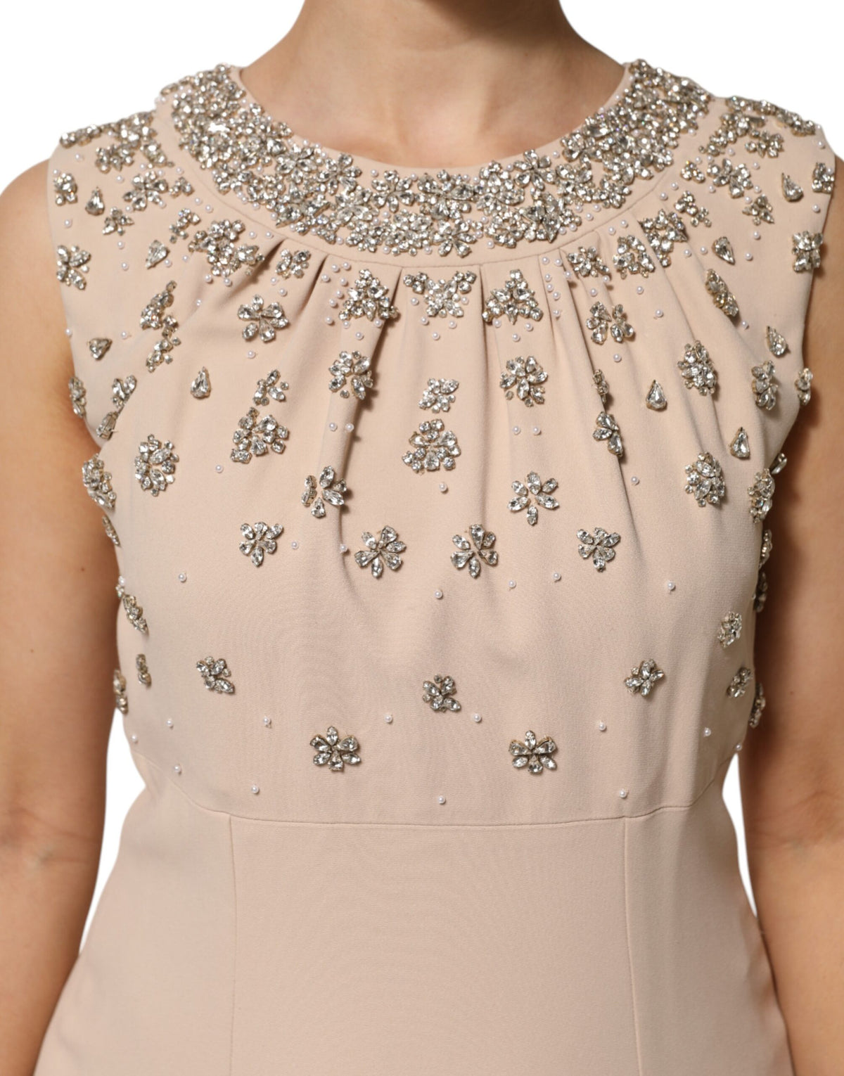 Indulge in the exquisite allure of the Dolce & Gabbana Nude Ecru Beaded Crystal Embellished Dress, where luxurious silk and intricate embellishments create a timeless statement of elegance.