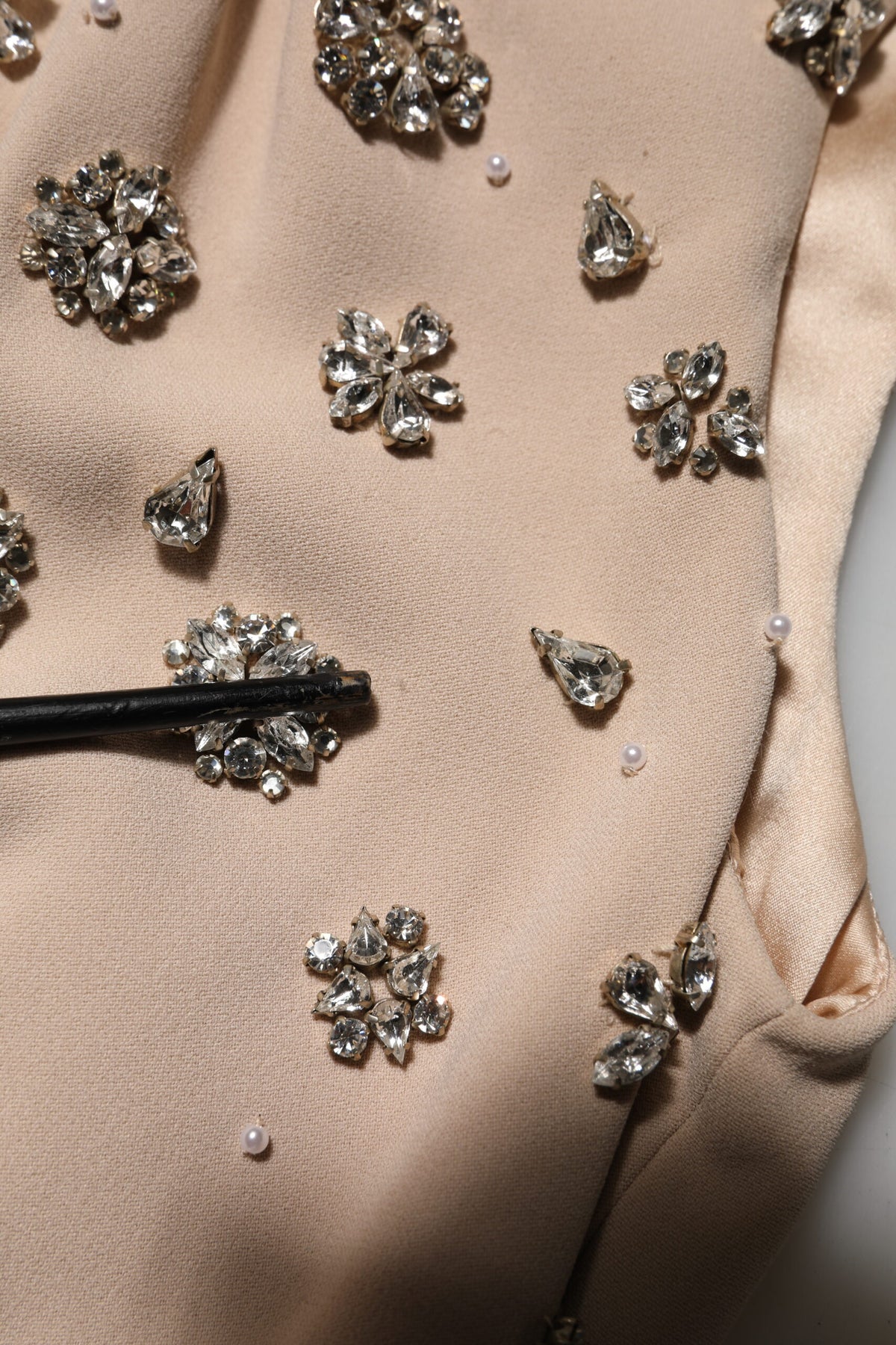 Indulge in the exquisite allure of the Dolce & Gabbana Nude Ecru Beaded Crystal Embellished Dress, a masterpiece of haute couture craftsmanship that radiates opulence and sophistication.