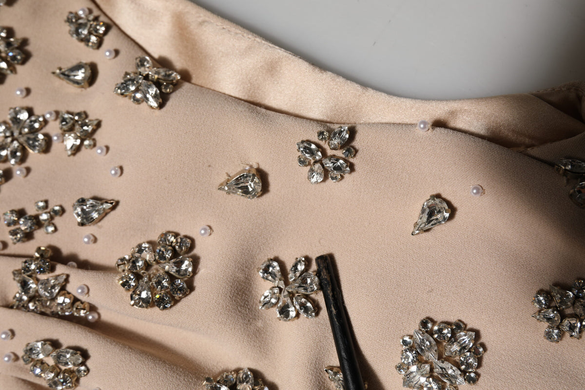 Indulge in the exquisite allure of the Dolce & Gabbana Nude Ecru Beaded Crystal Embellished Dress, where luxurious silk and intricate embellishments redefine haute couture elegance.