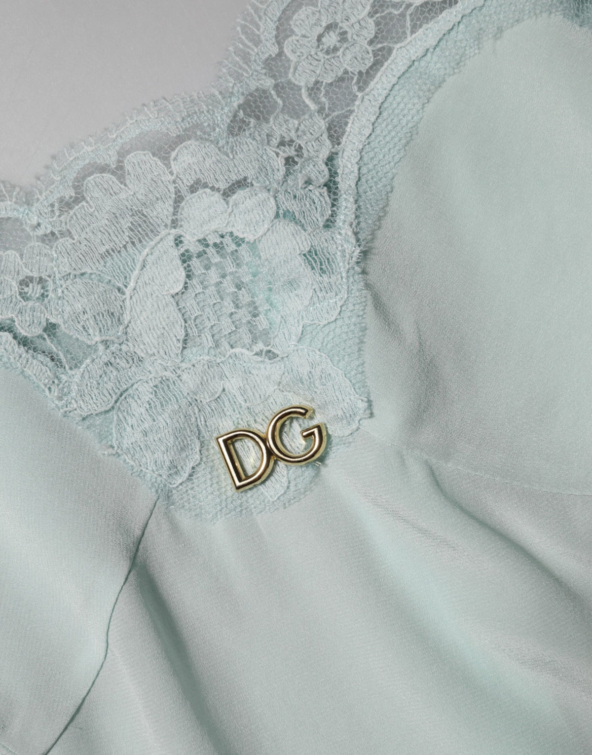 Indulge in the Dolce & Gabbana Light Blue Silk Lace Midi Bodycon Slip Dress, a luxurious blend of silk and lace that embodies timeless elegance and sensual sophistication.