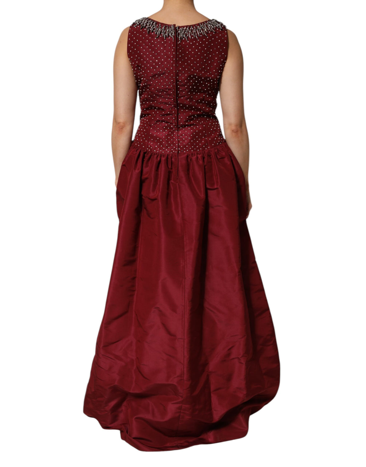 Indulge in the allure of the Dolce & Gabbana Burgundy Silk Beaded Evening Gown, a masterpiece of Italian craftsmanship that embodies elegance and timeless sophistication.