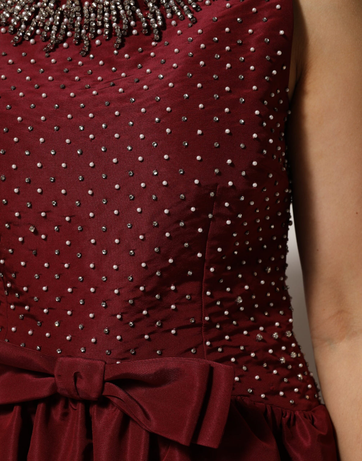 Indulge in the allure of the Dolce & Gabbana Burgundy Silk Beaded Evening Gown, a timeless masterpiece crafted from luxurious silk and exquisite beading, embodying elegance and sophistication for any discerning individual.