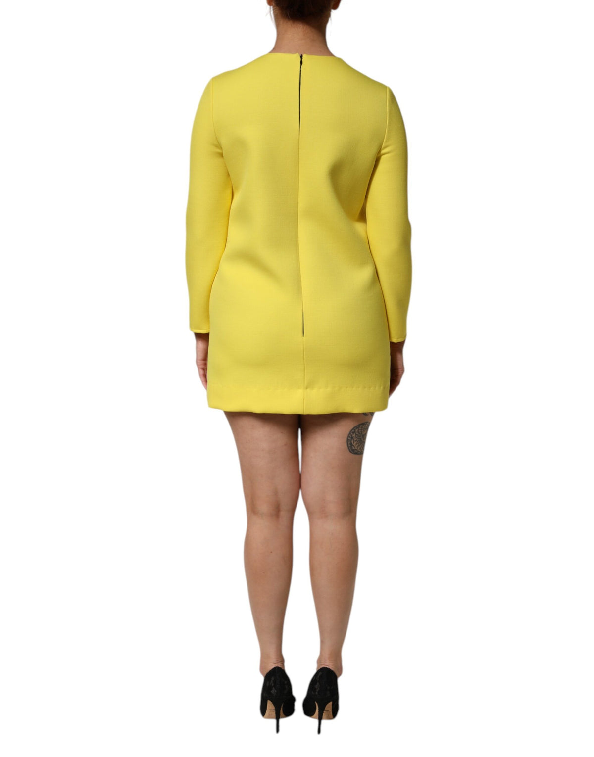 Indulge in the exquisite Dolce & Gabbana Yellow Viscose Acetate Mini Long Sleeve Dress, a timeless piece crafted in Italy, embodying luxury and sophistication for the discerning individual.