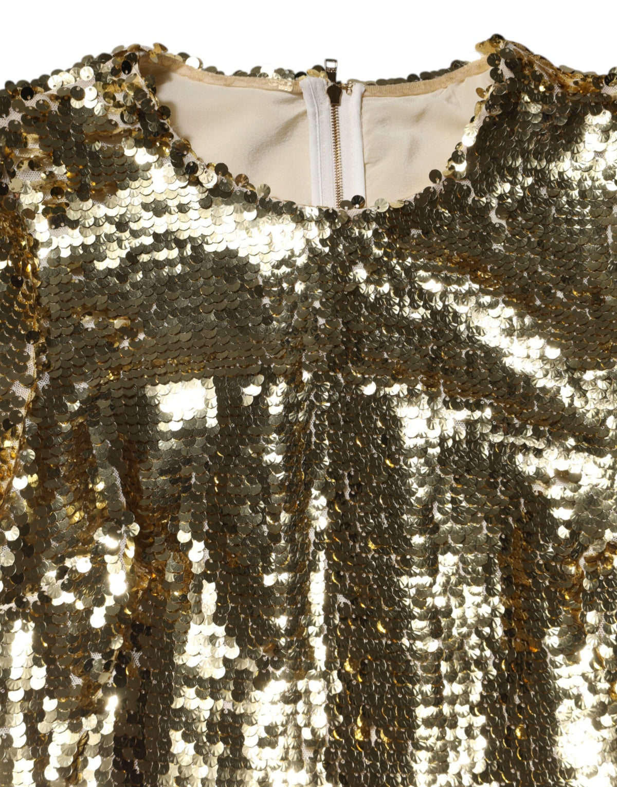 Indulge in the opulent allure of the Dolce & Gabbana Gold Sequin Long Sleeve Mini Dress, where exquisite craftsmanship meets luxurious silk lining for unforgettable elegance.