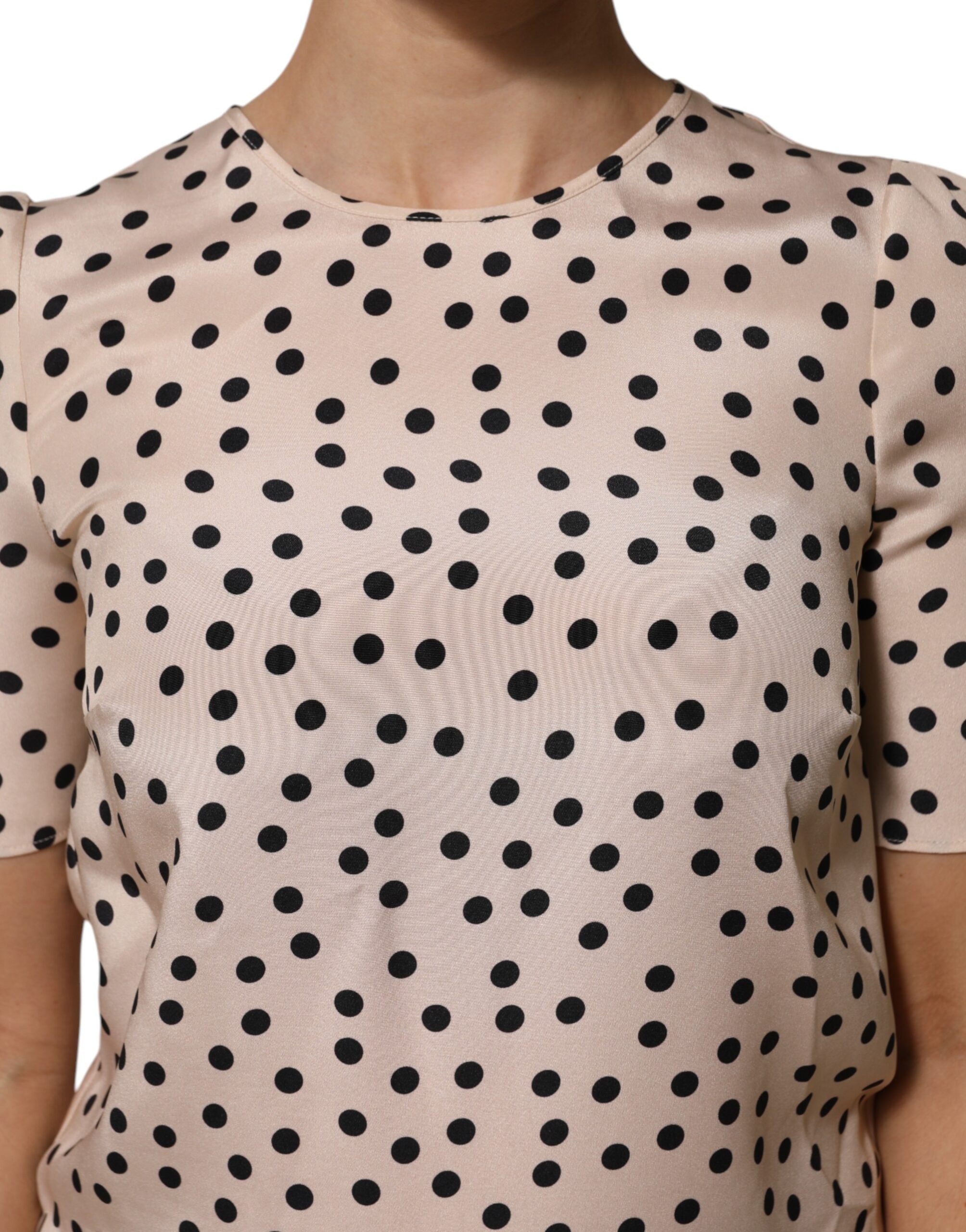 Elevate your wardrobe with the Dolce & Gabbana Beige Black Polka Dot Silk Blouse, a masterpiece of Italian craftsmanship that embodies timeless elegance and playful sophistication.