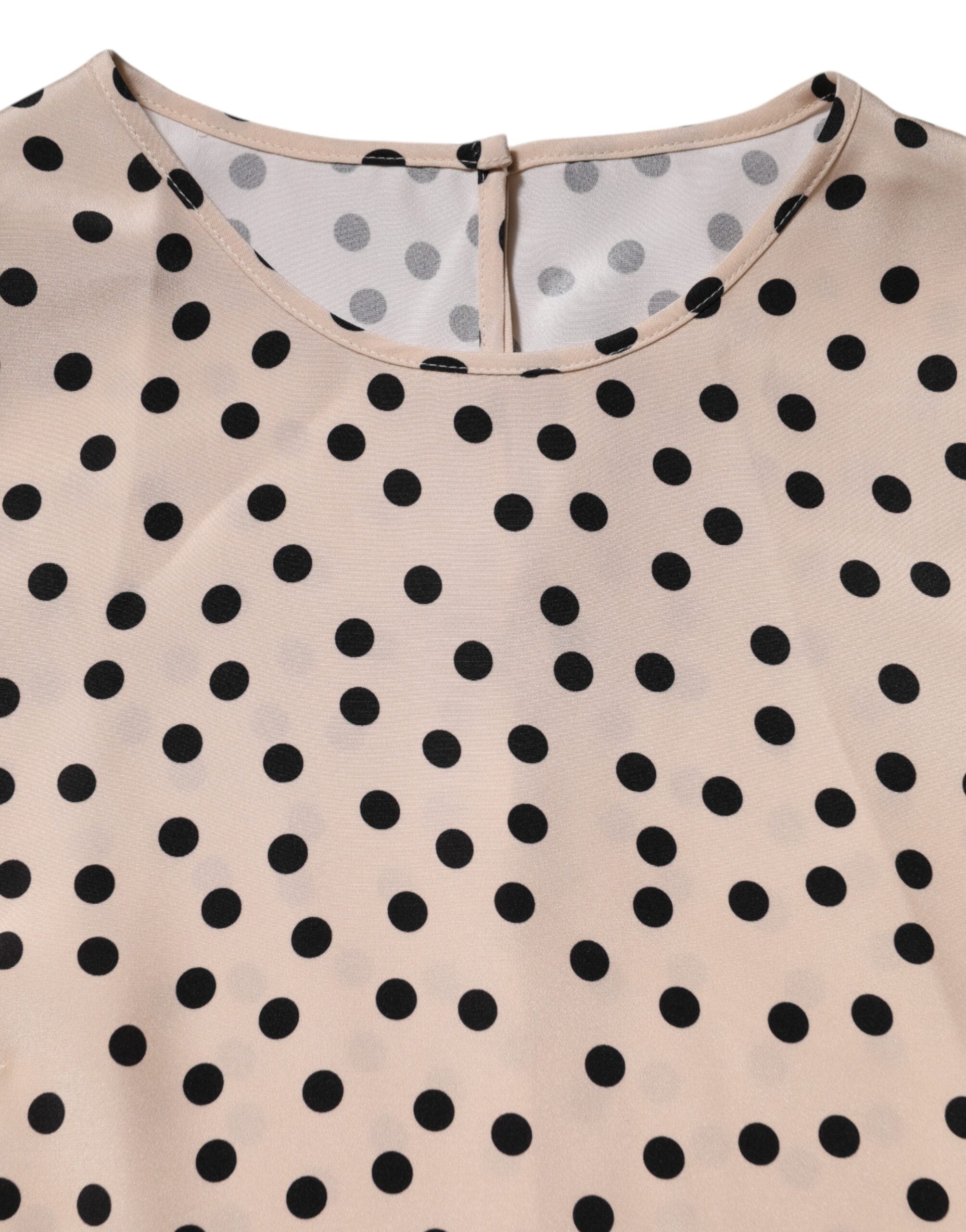 Indulge in the elegance of Dolce & Gabbana's Beige Black Polka Dot Silk Short Sleeve Blouse, a masterpiece of Italian craftsmanship that embodies timeless sophistication and playful allure.