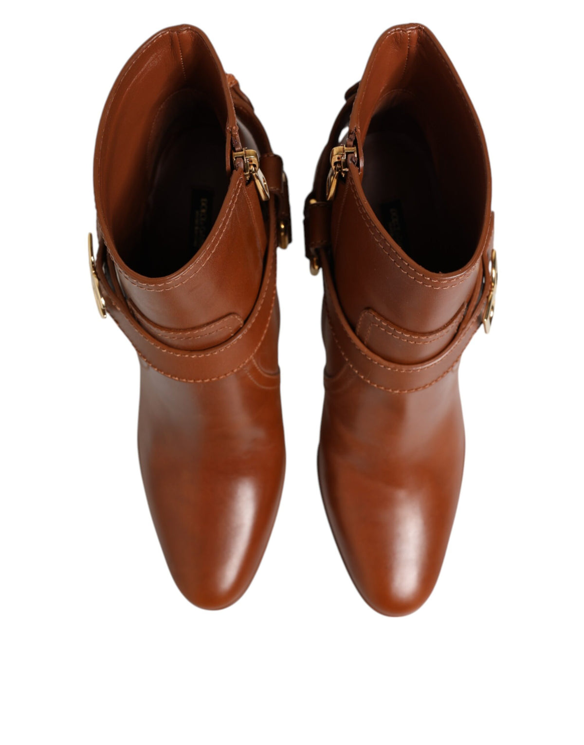 Elevate your style with Dolce & Gabbana's Brown Leather DG Logo Buckle Ankle Boots, crafted from luxurious calf leather, embodying sophistication and timeless allure.